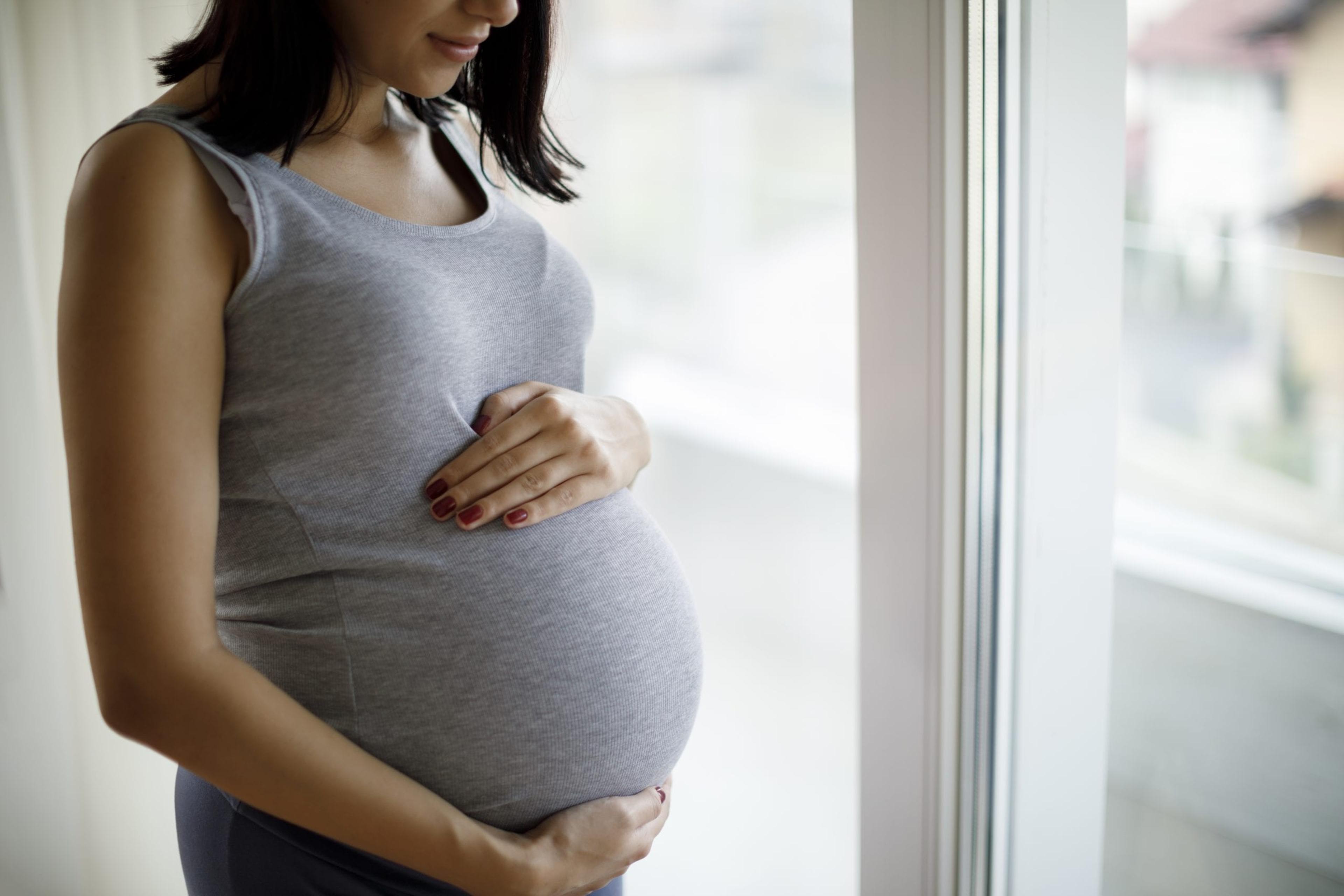 Pregnant woman holding stomach