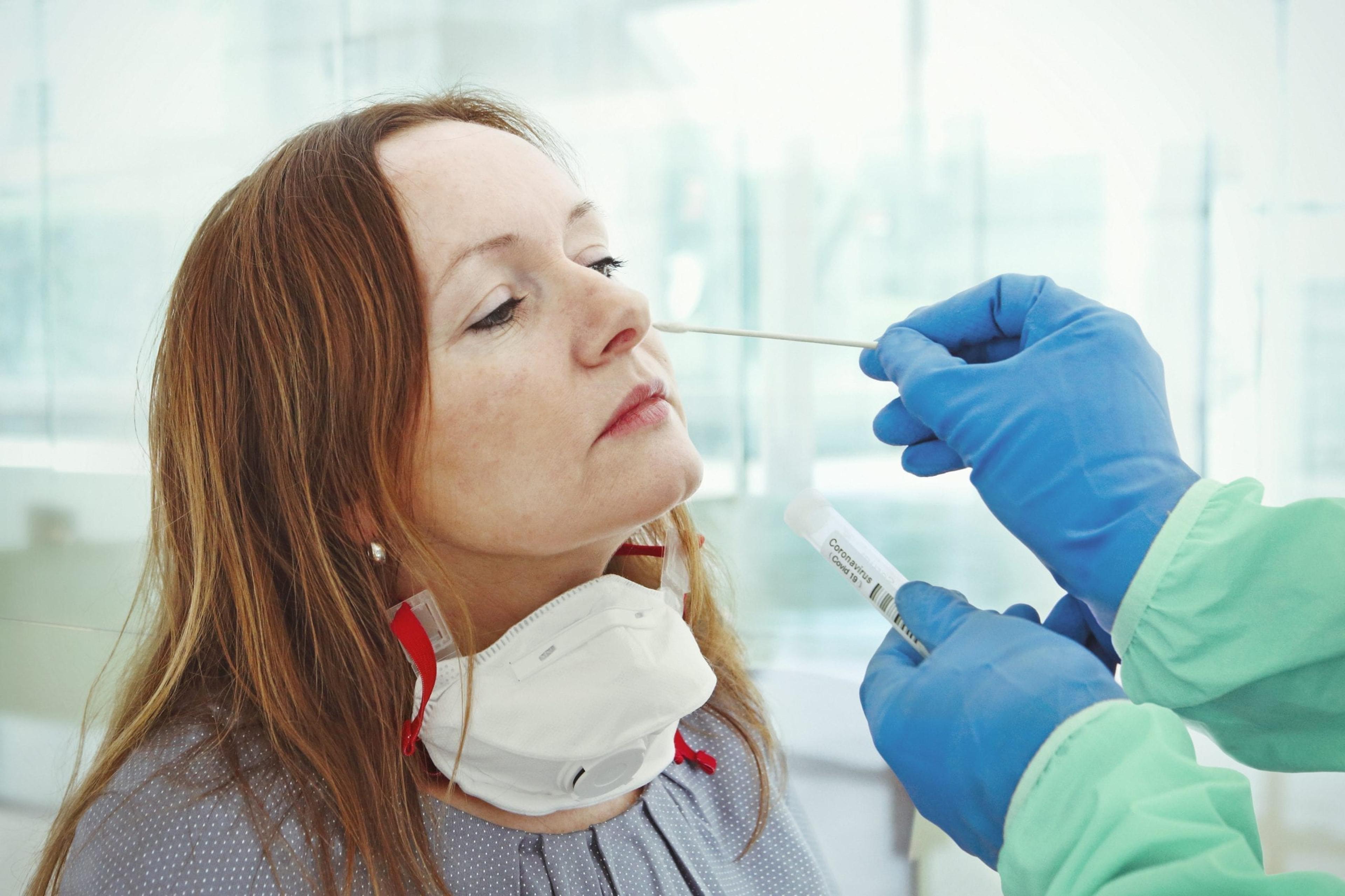Woman receiving a nose swab test