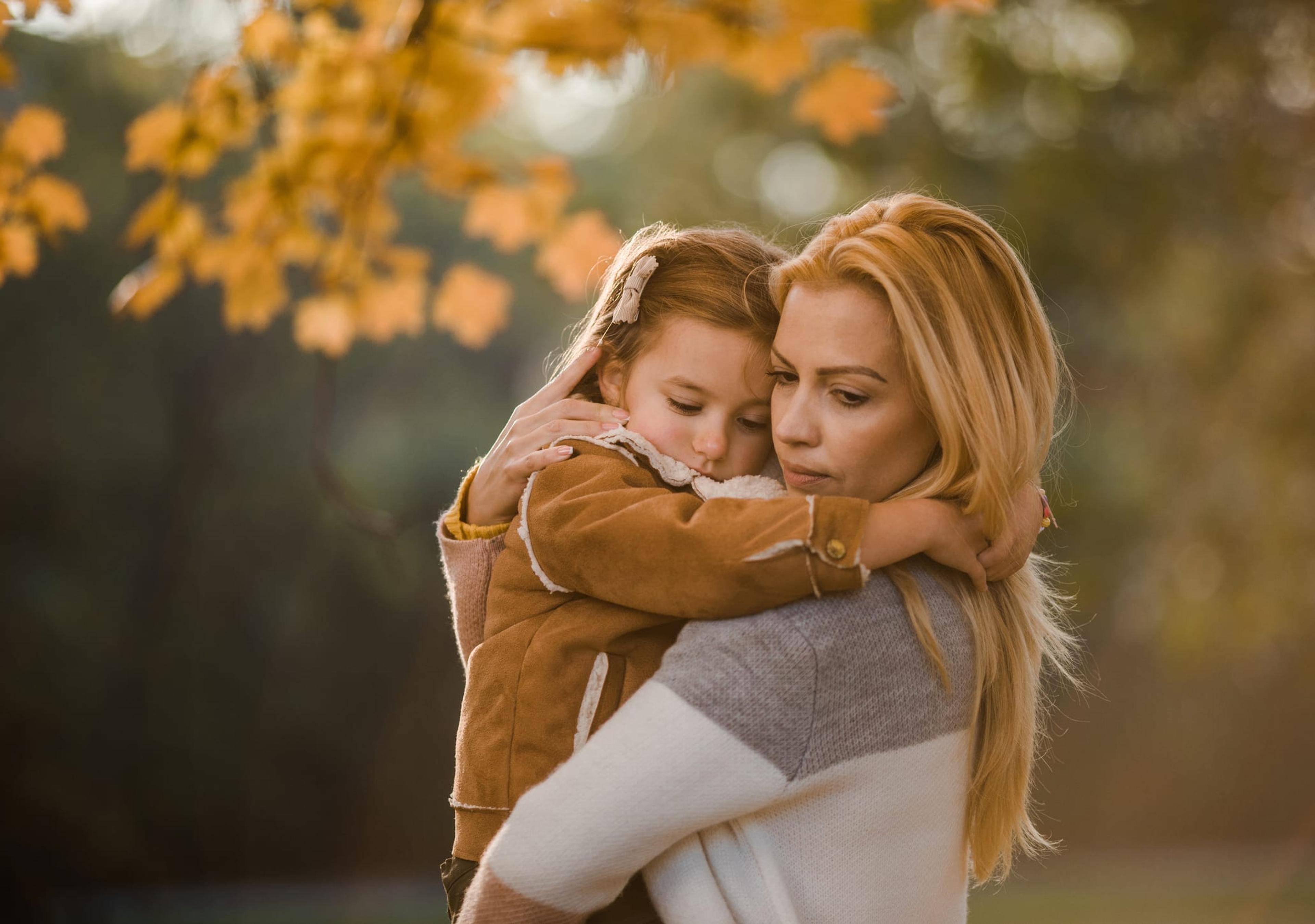 Blonde mother consoling daughter