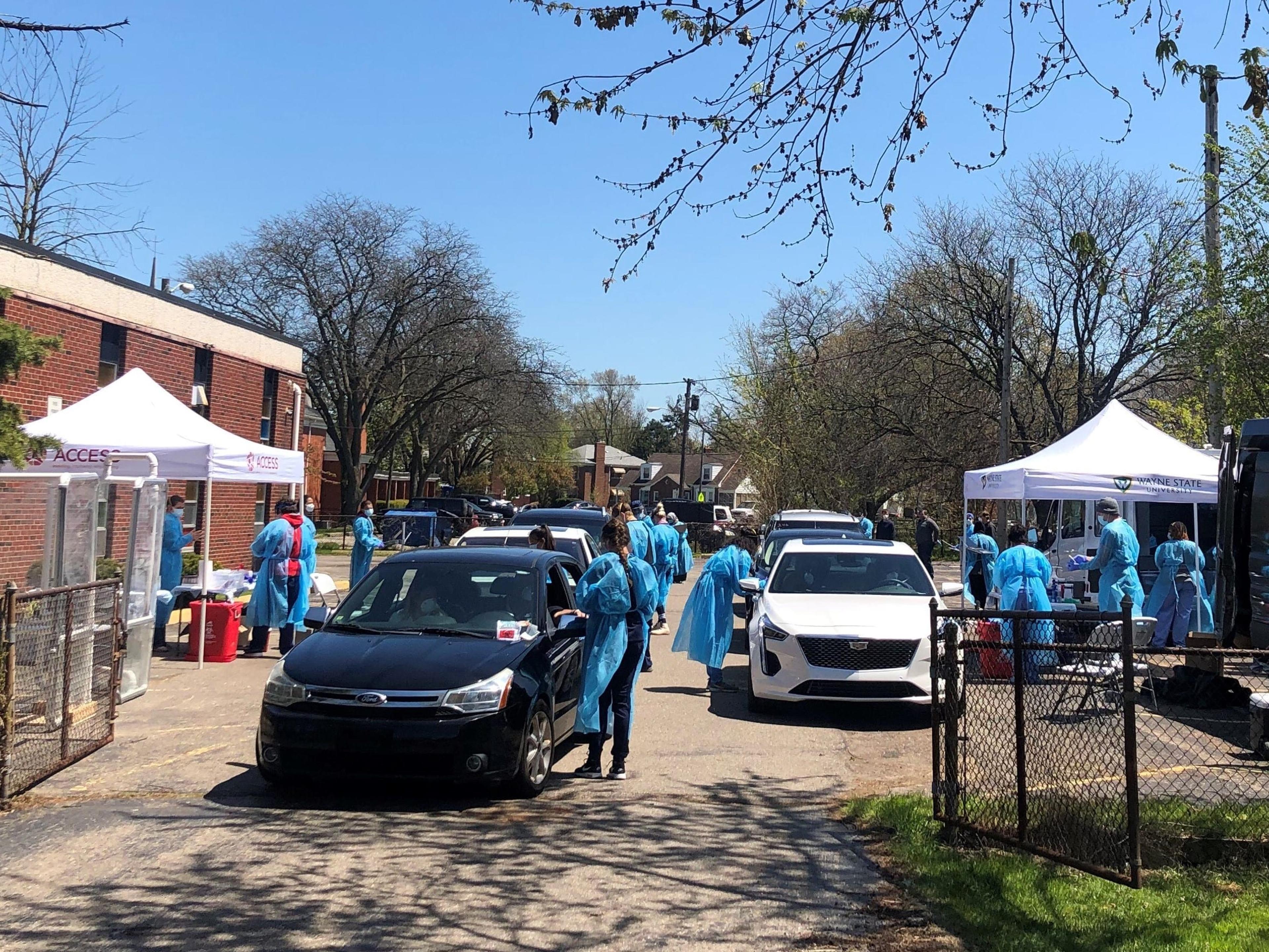 Health workers conduct drive-through COVID-19 testing