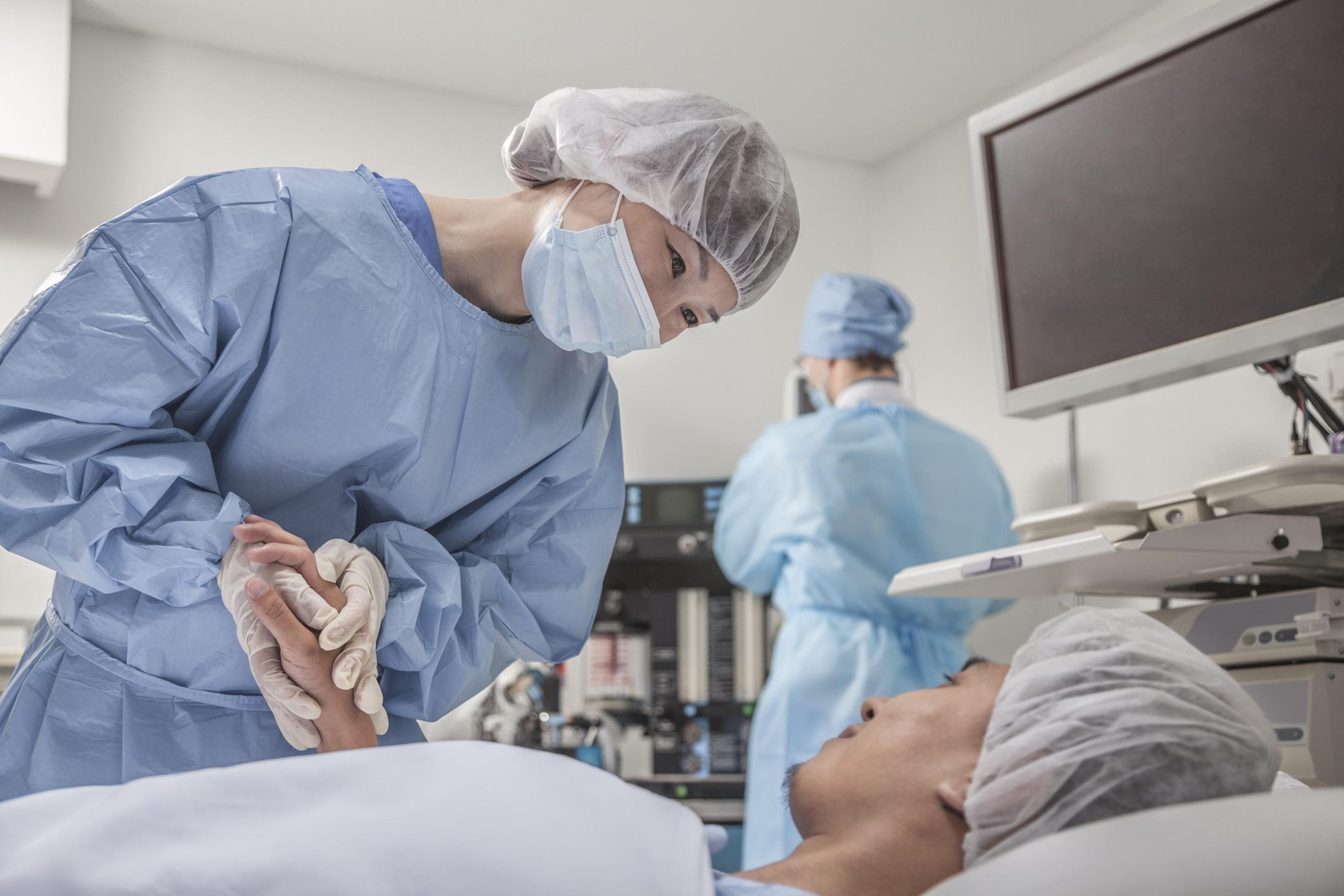 Surgeon consulting a patient, holding hands, getting ready for surgery