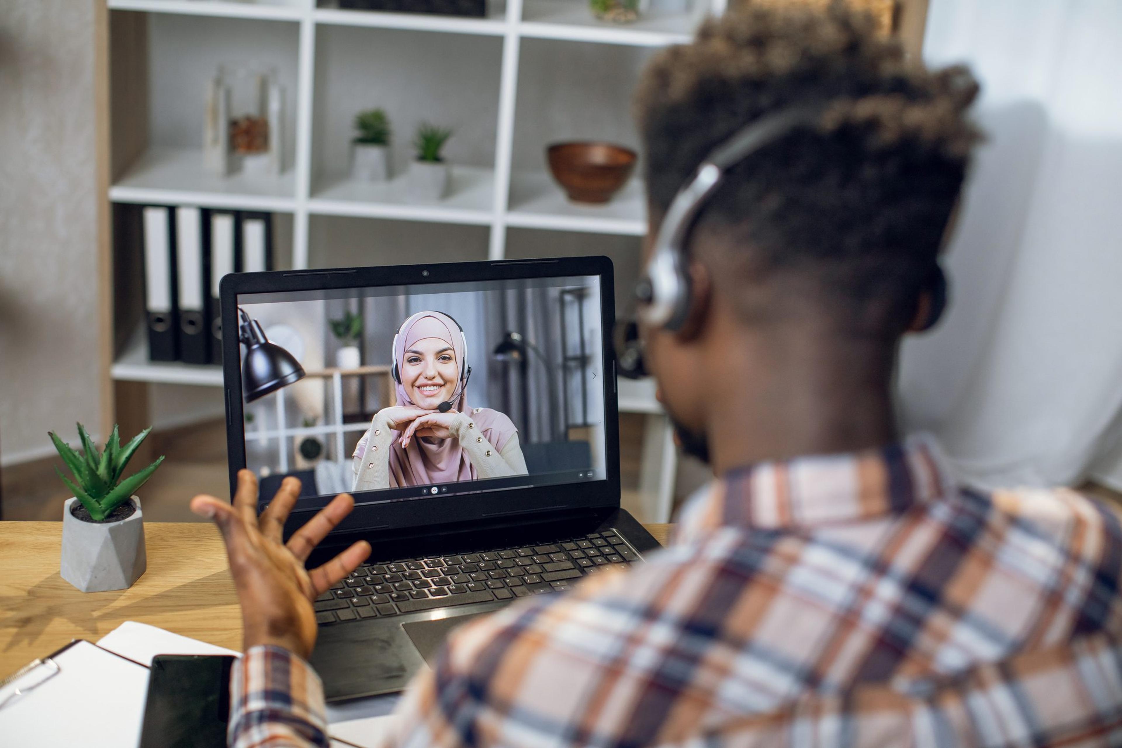 Man has a virtual telehealth therapy session through his laptop