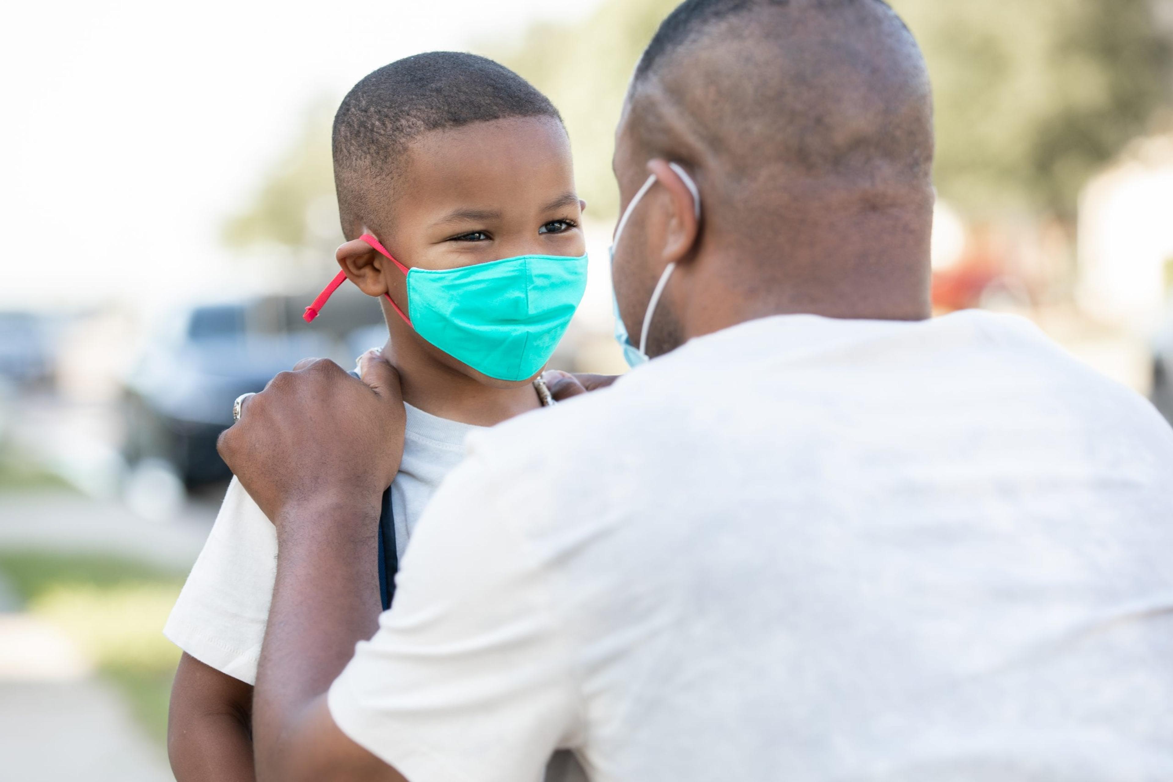 Man encouraging young boy