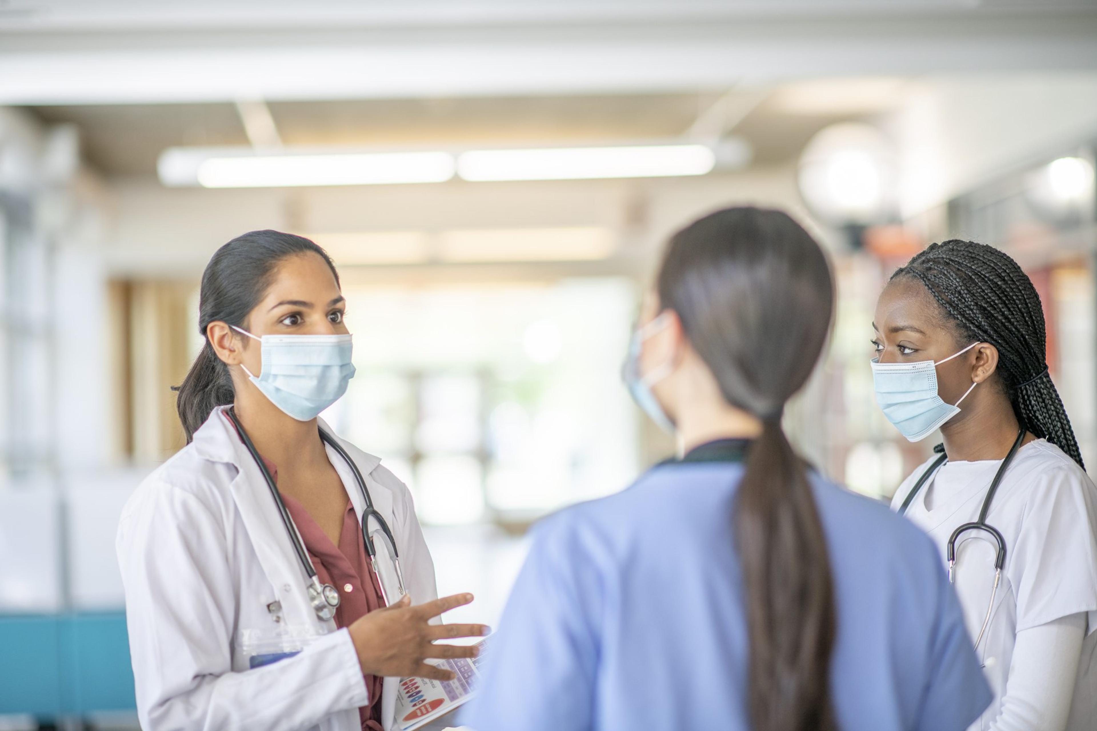 Doctor speaks with nurse team