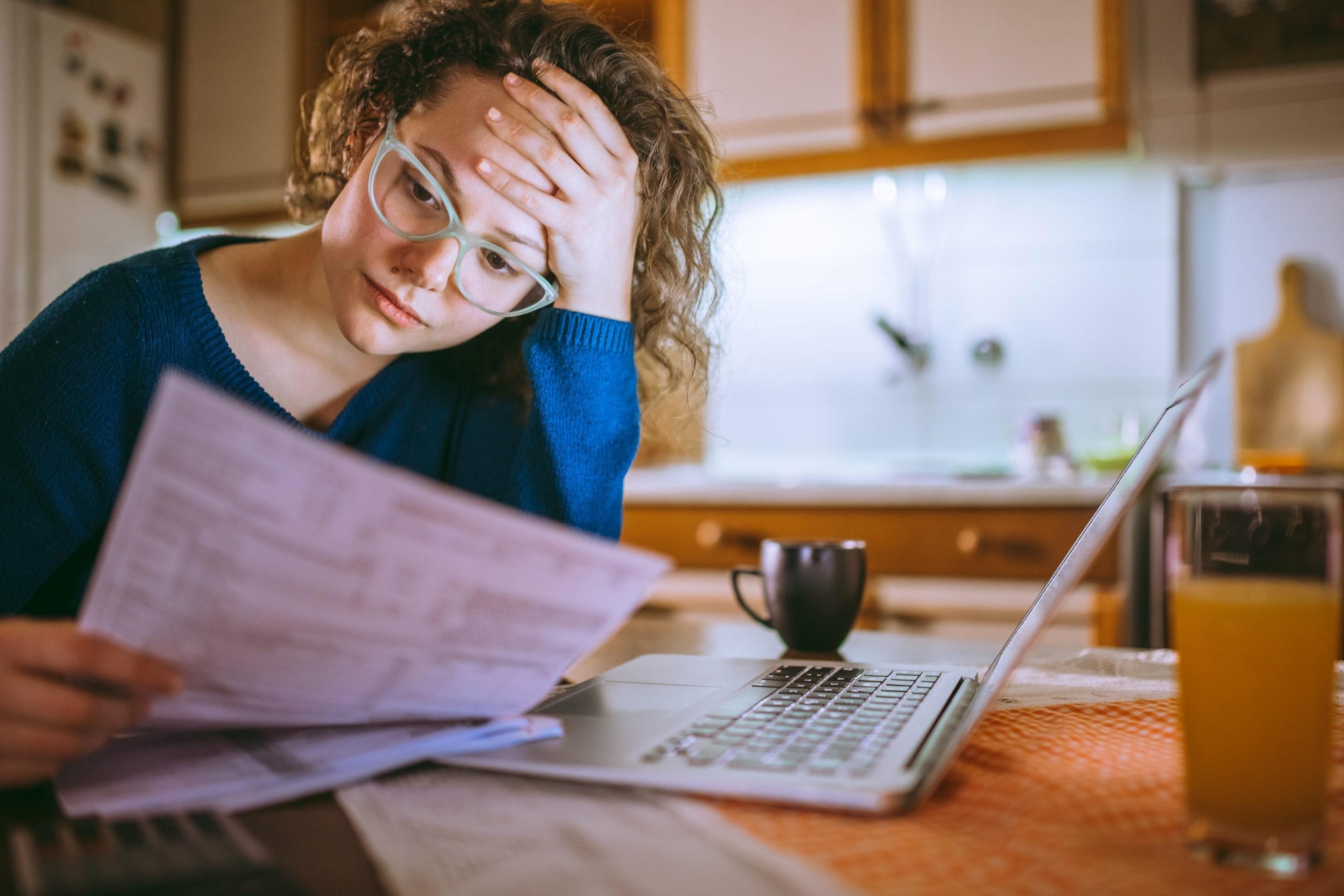 Woman stressed looking at bills