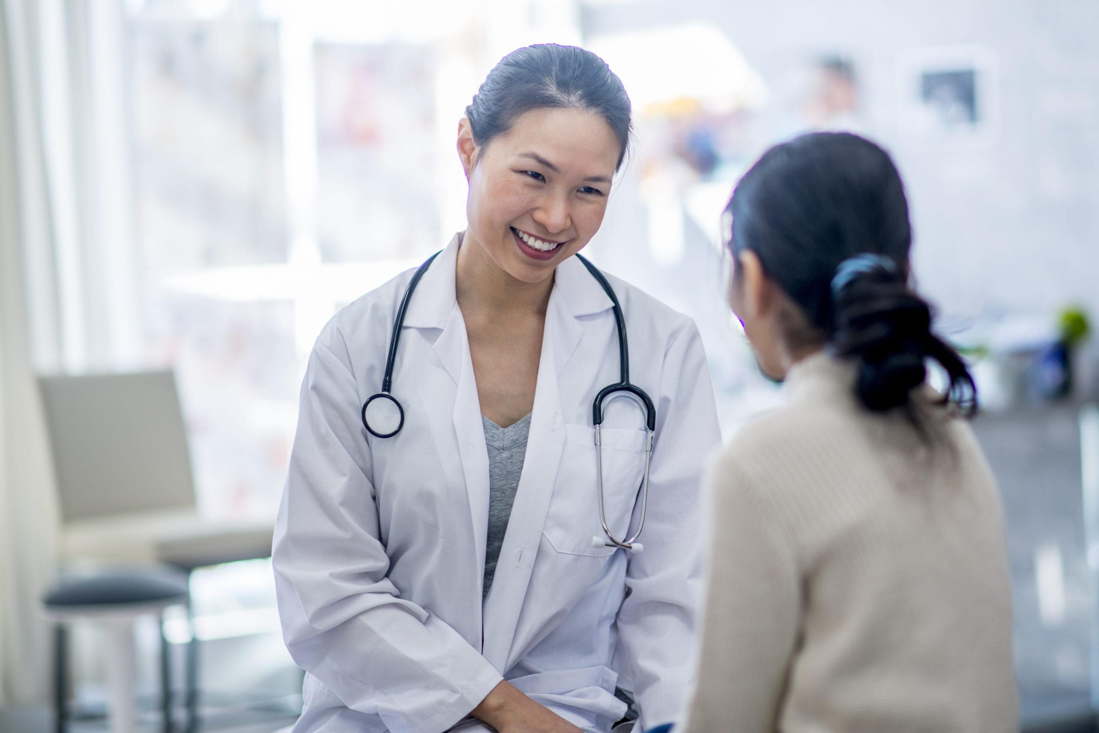 A female doctor talking to a female patient about her health