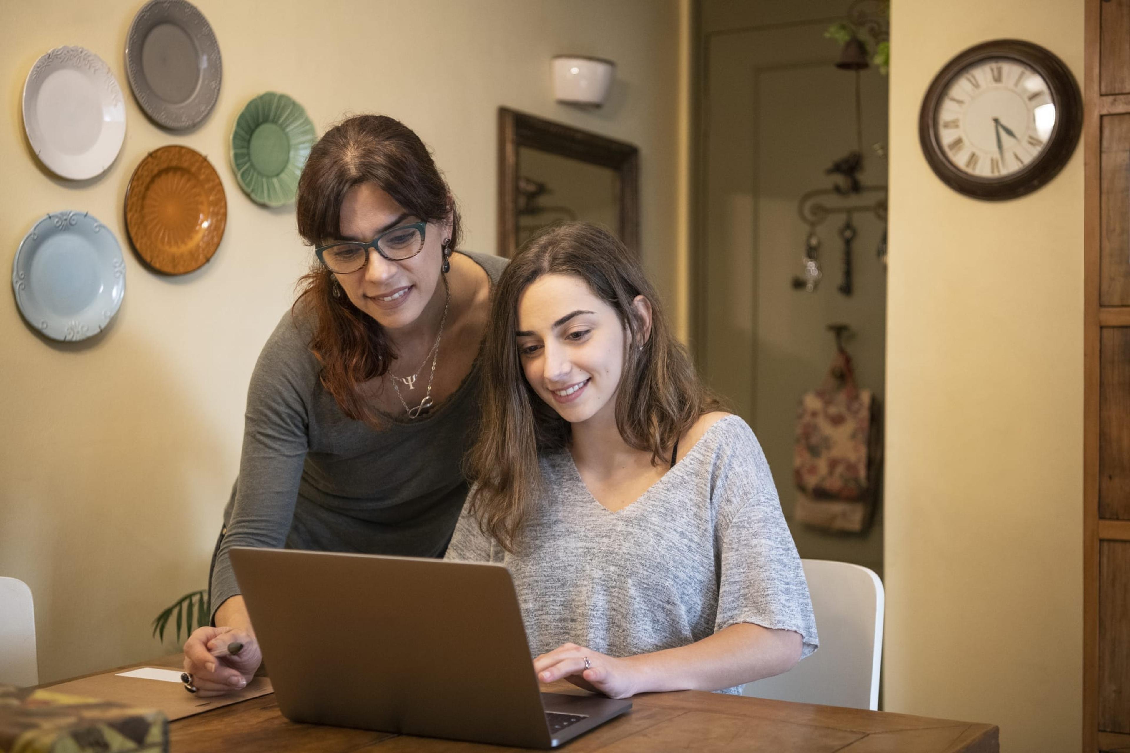 Mom helping teen daughter with online classes