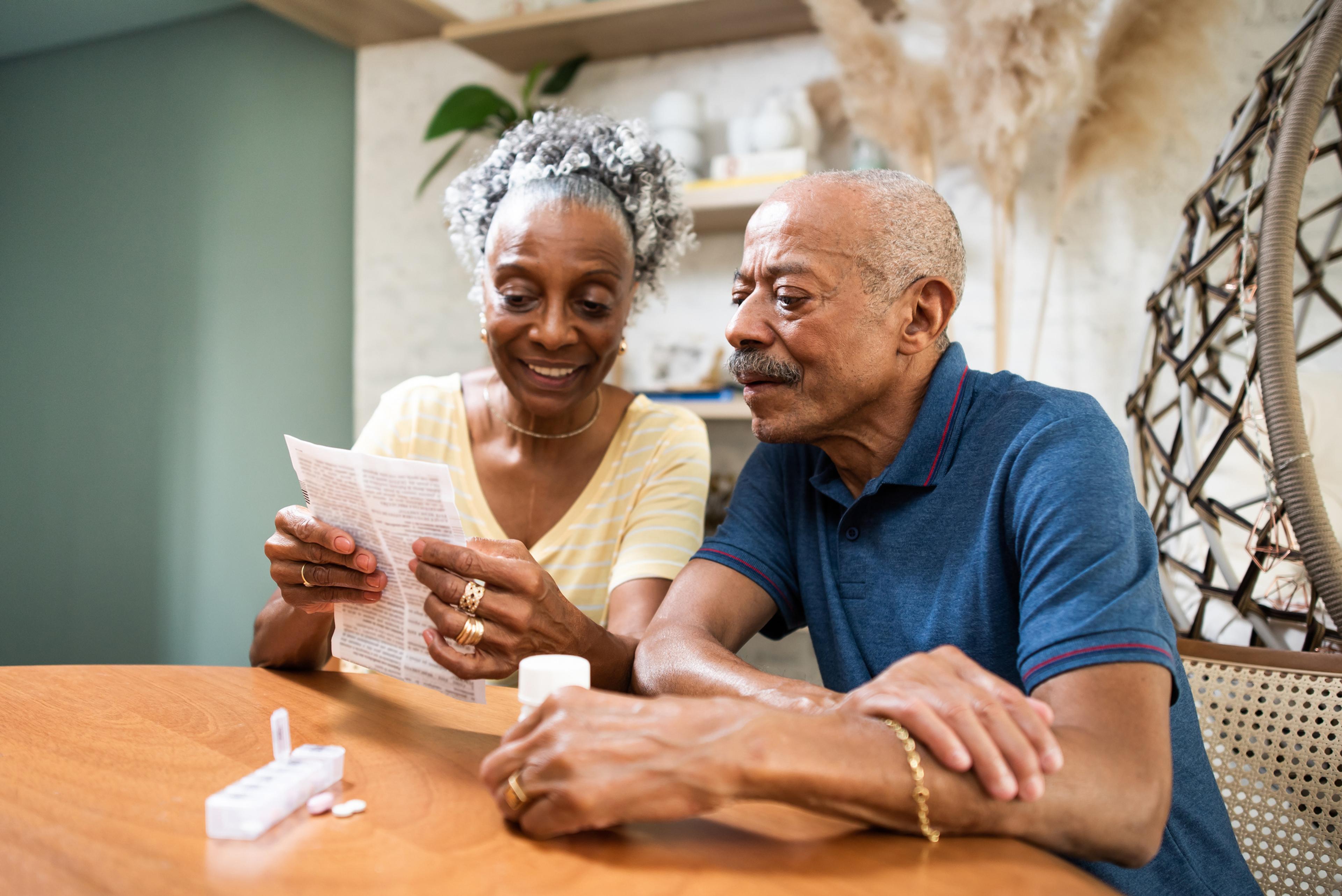 Man and woman look at prescription medications