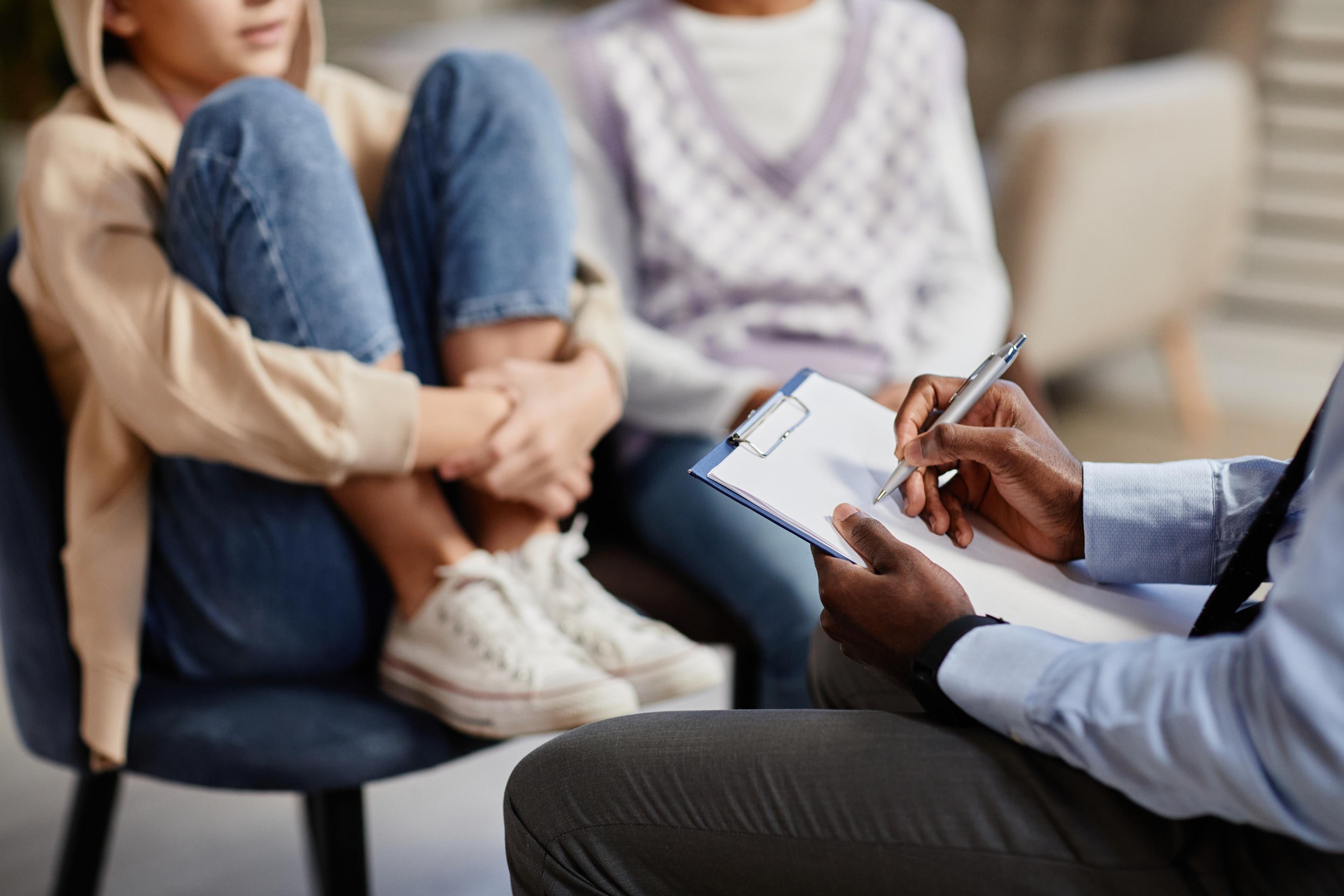 teen sits in a chair during a therapy session