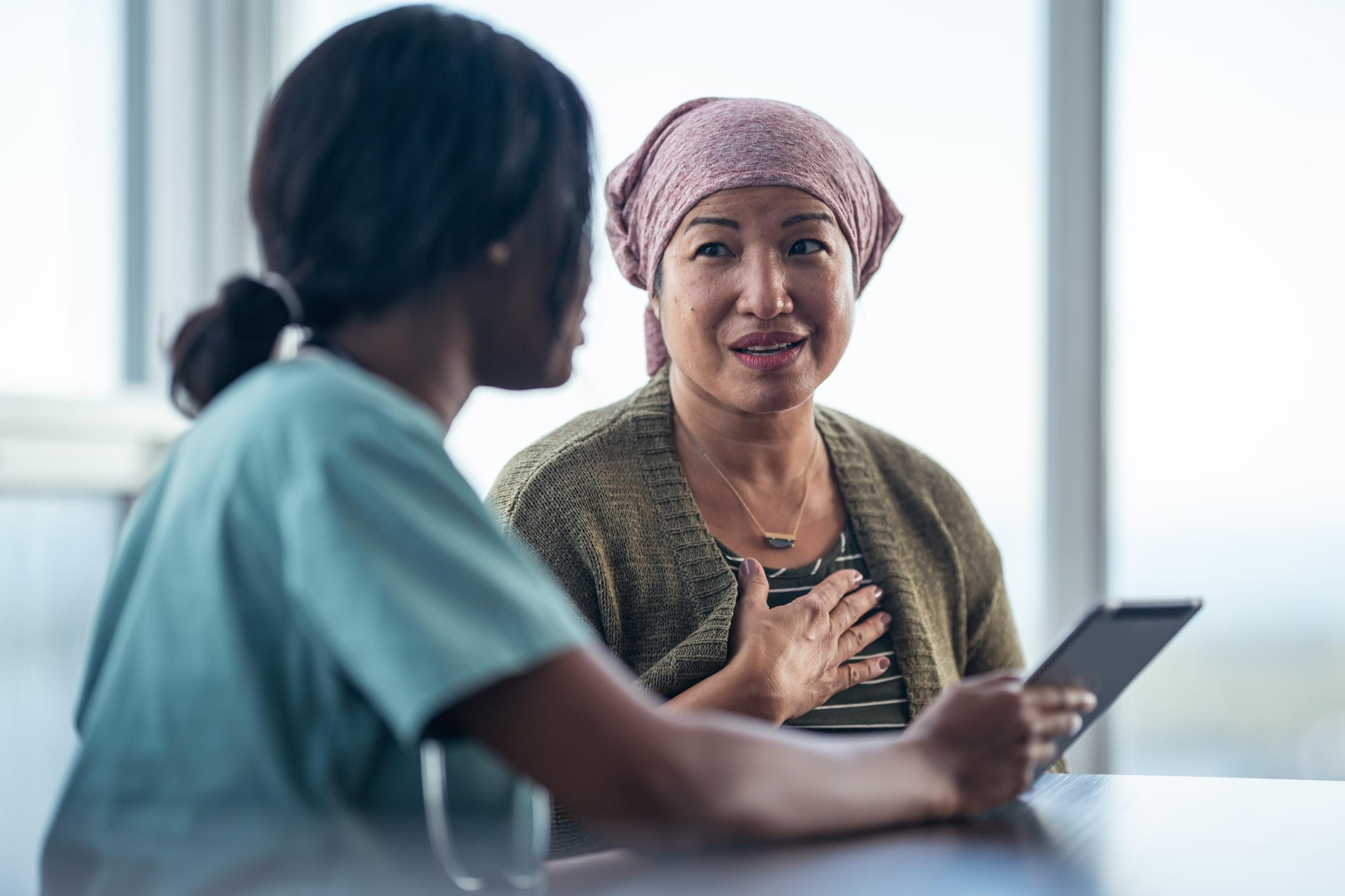 An Asian woman with cancer is consulting her doctor.