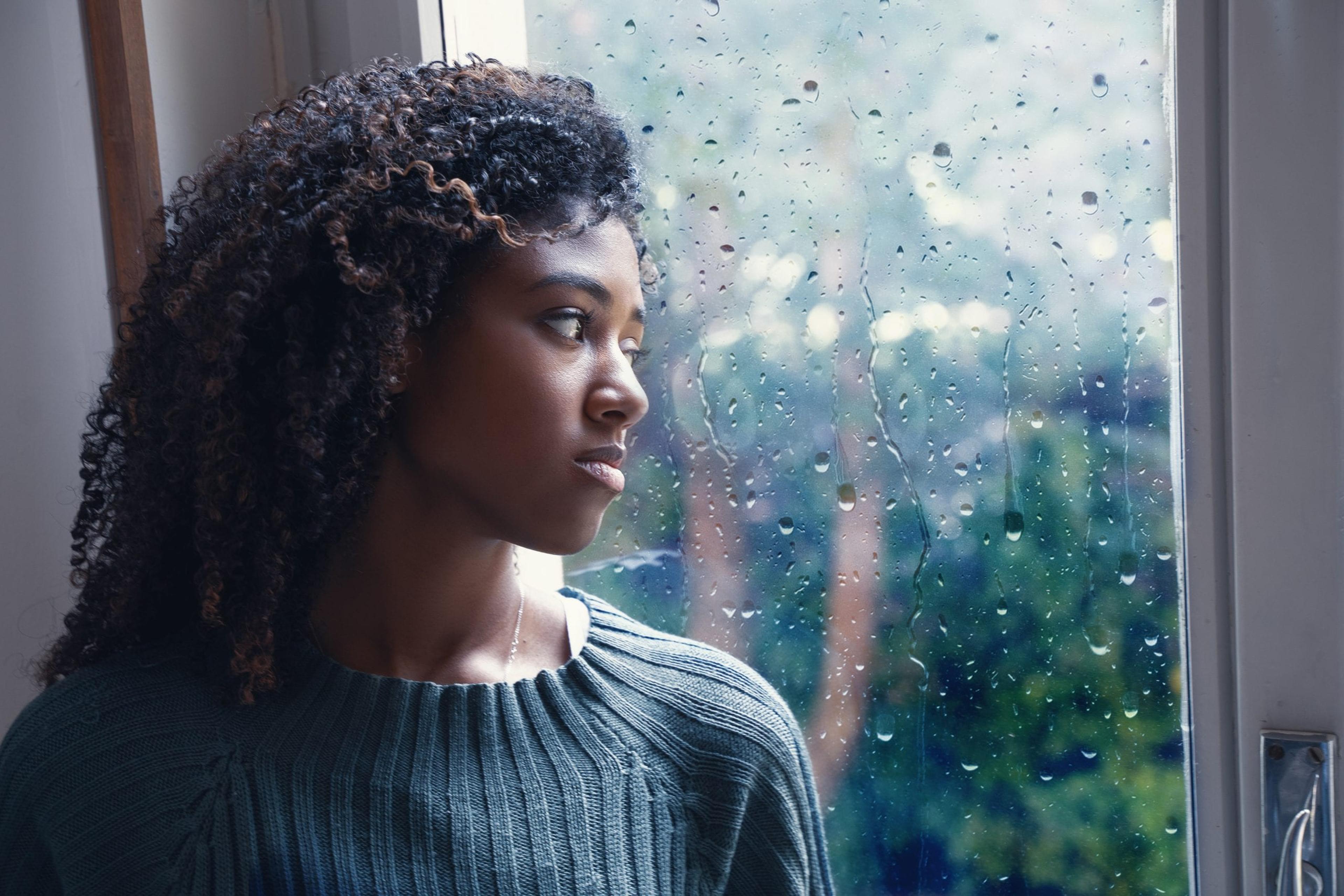 Black woman feeling depression symptoms alone at home