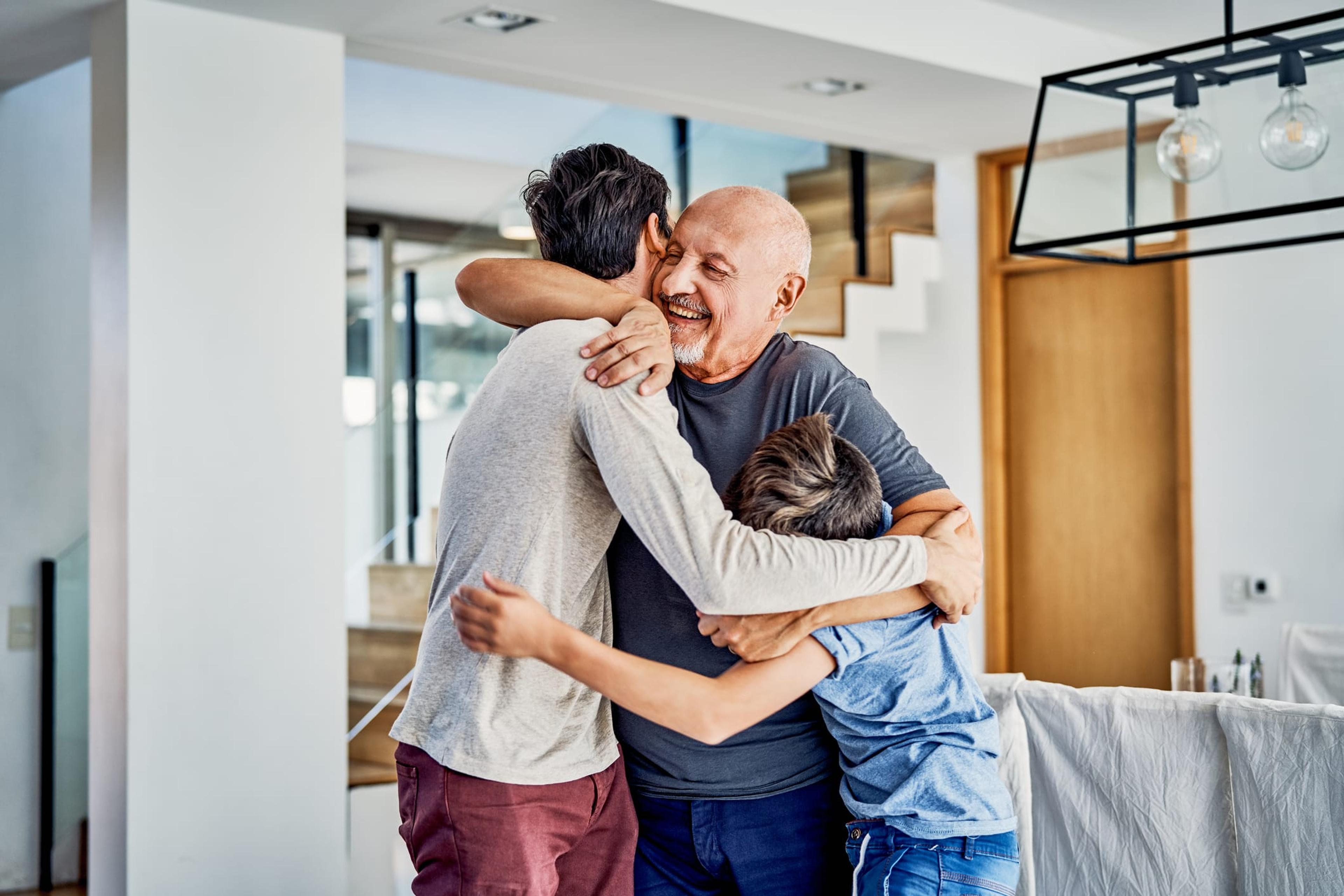 Man hugs his grandchildren after receiving a COVID vaccine