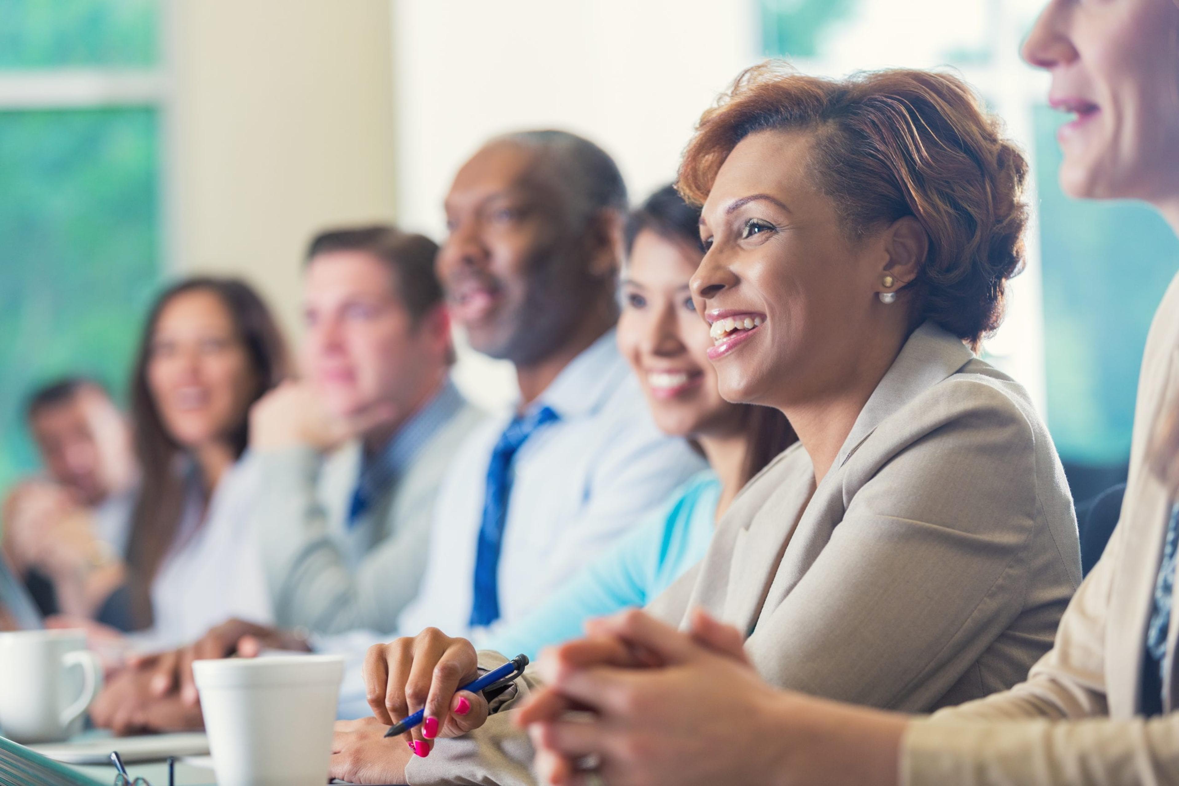 Diverse group of co-workers listening to a presentation.