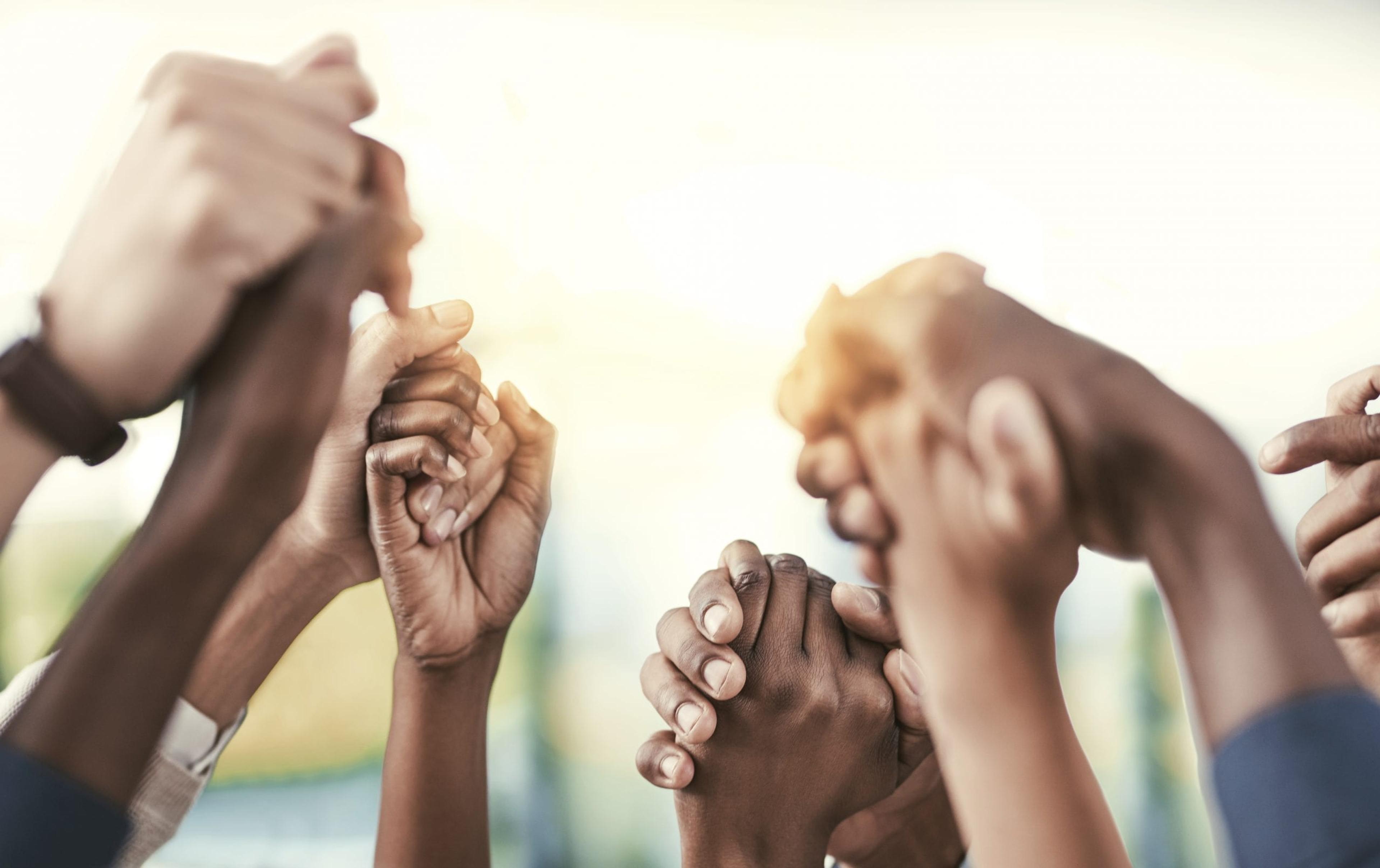 People holding hands in the air