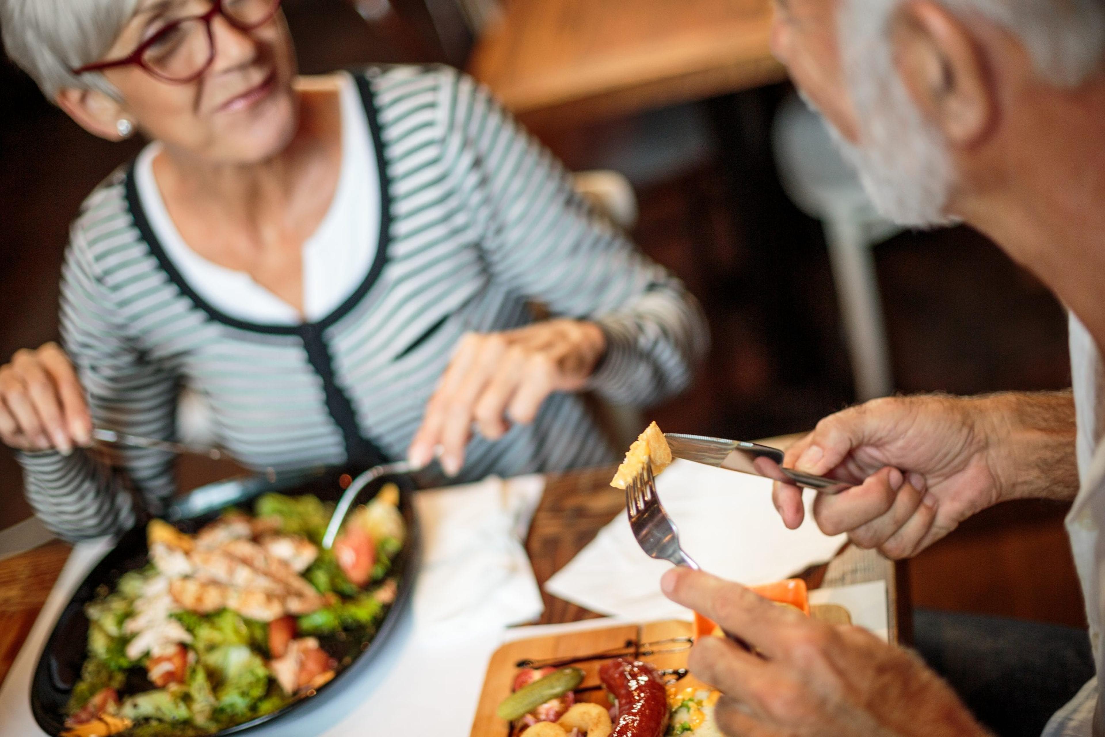 Senior couple eating out.