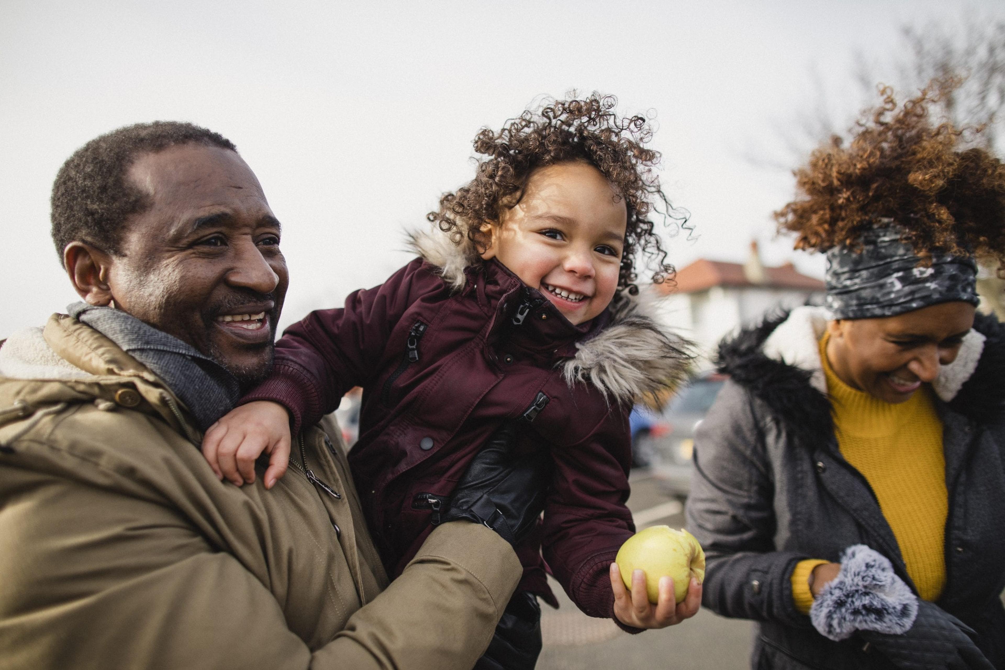 Grandparents playing with young girl