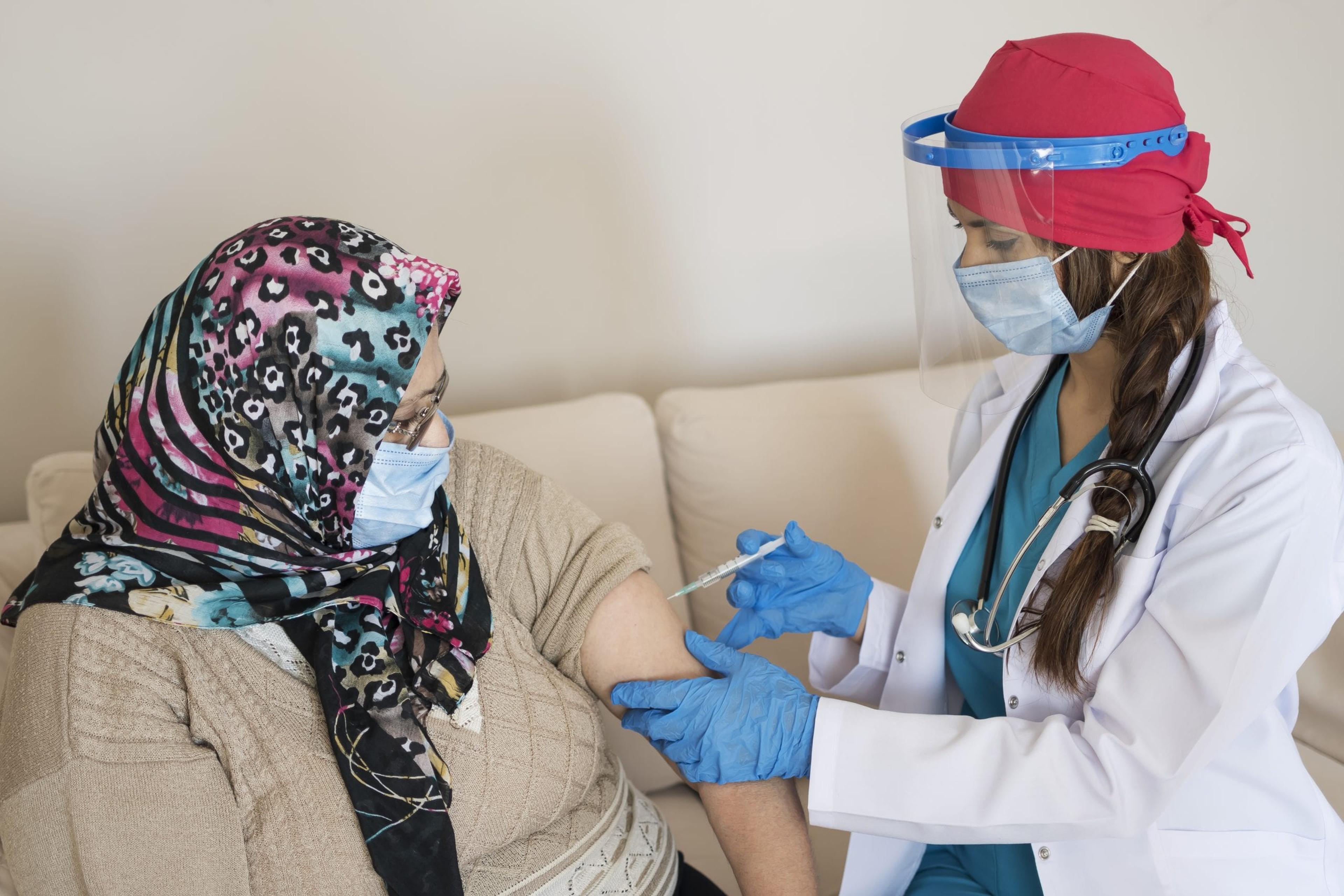 Doctor giving a woman a shot