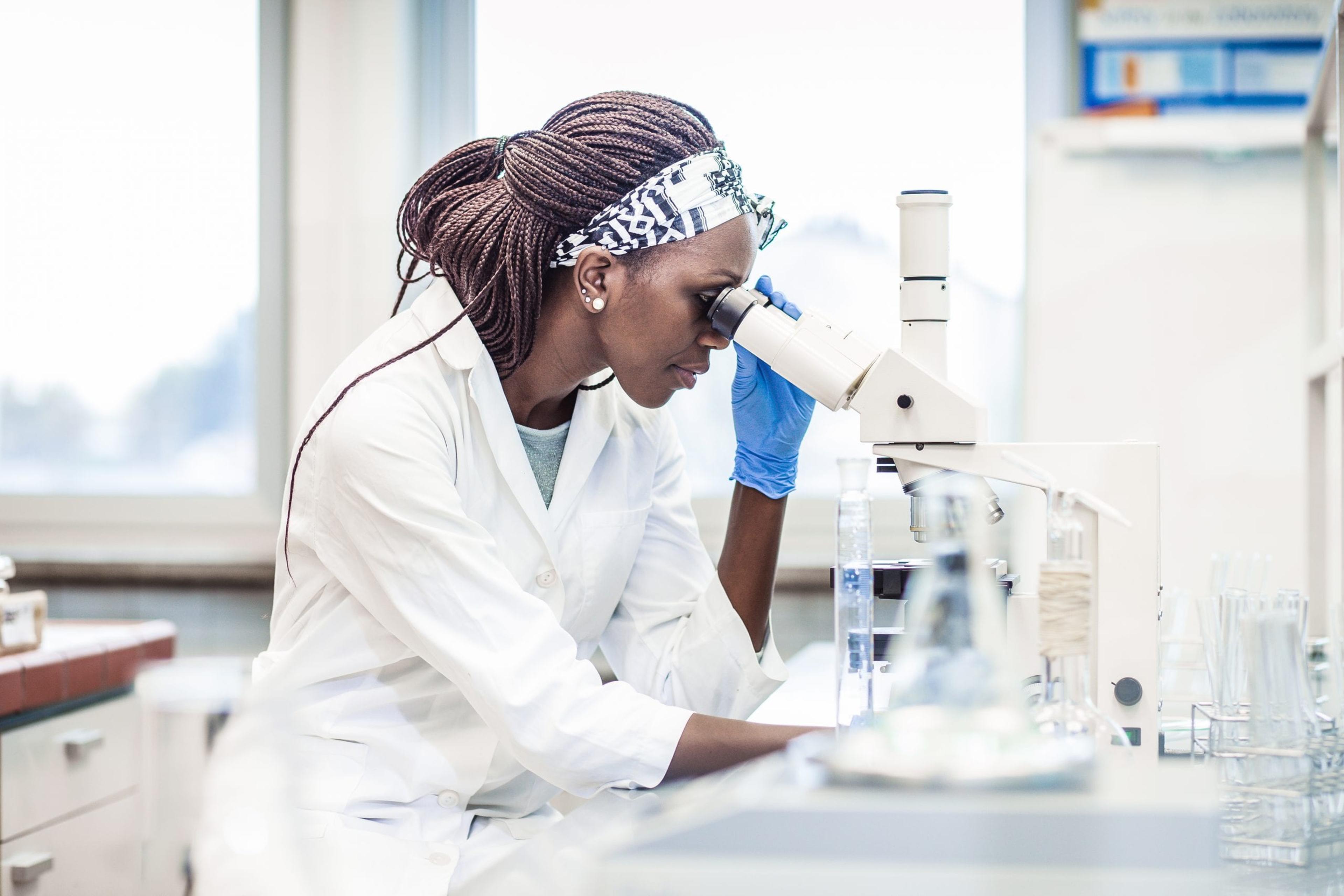 Scientist looking through a microscope