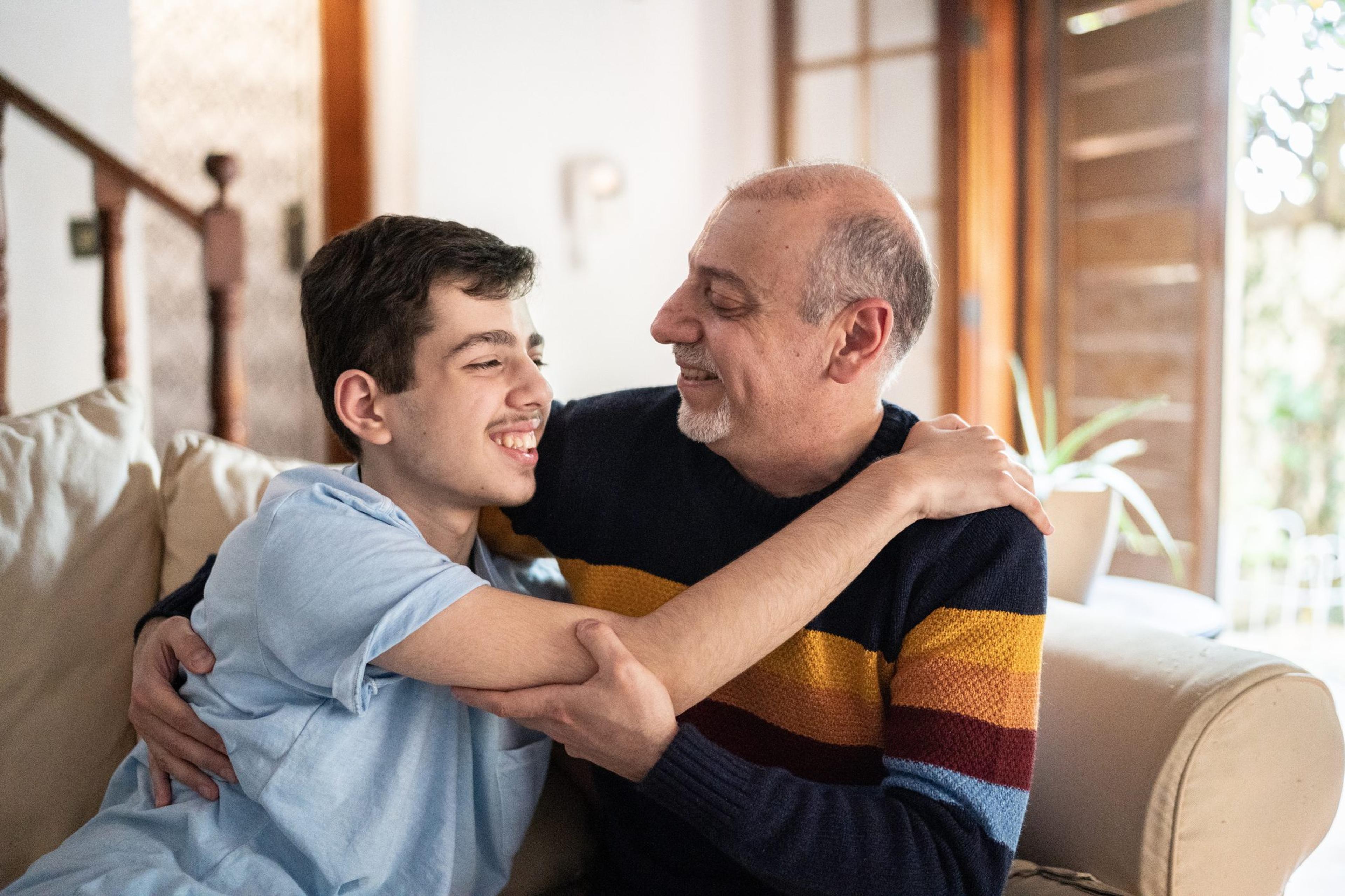 Father and son hugging each other at home