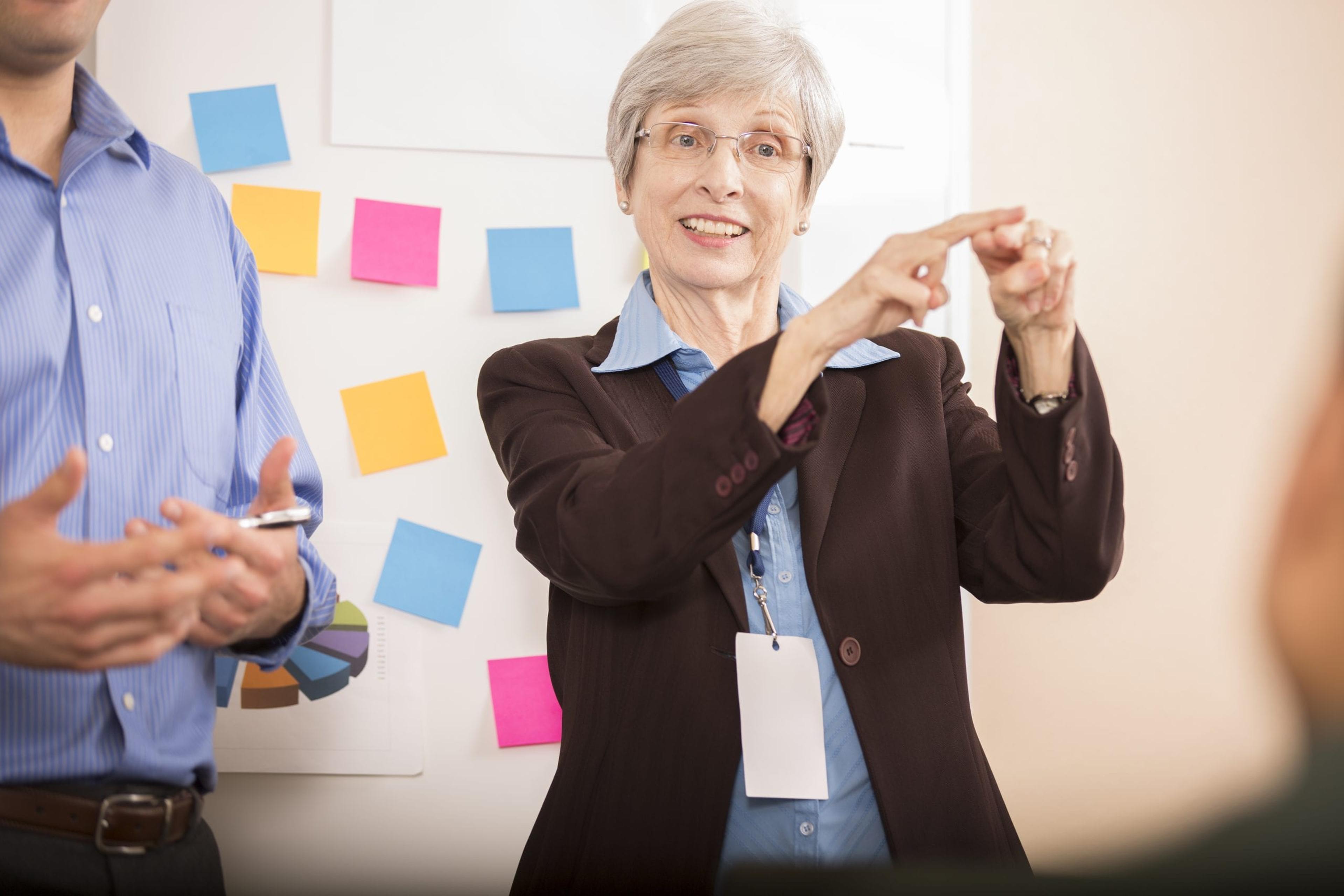 Woman using sign language at a business meeting.