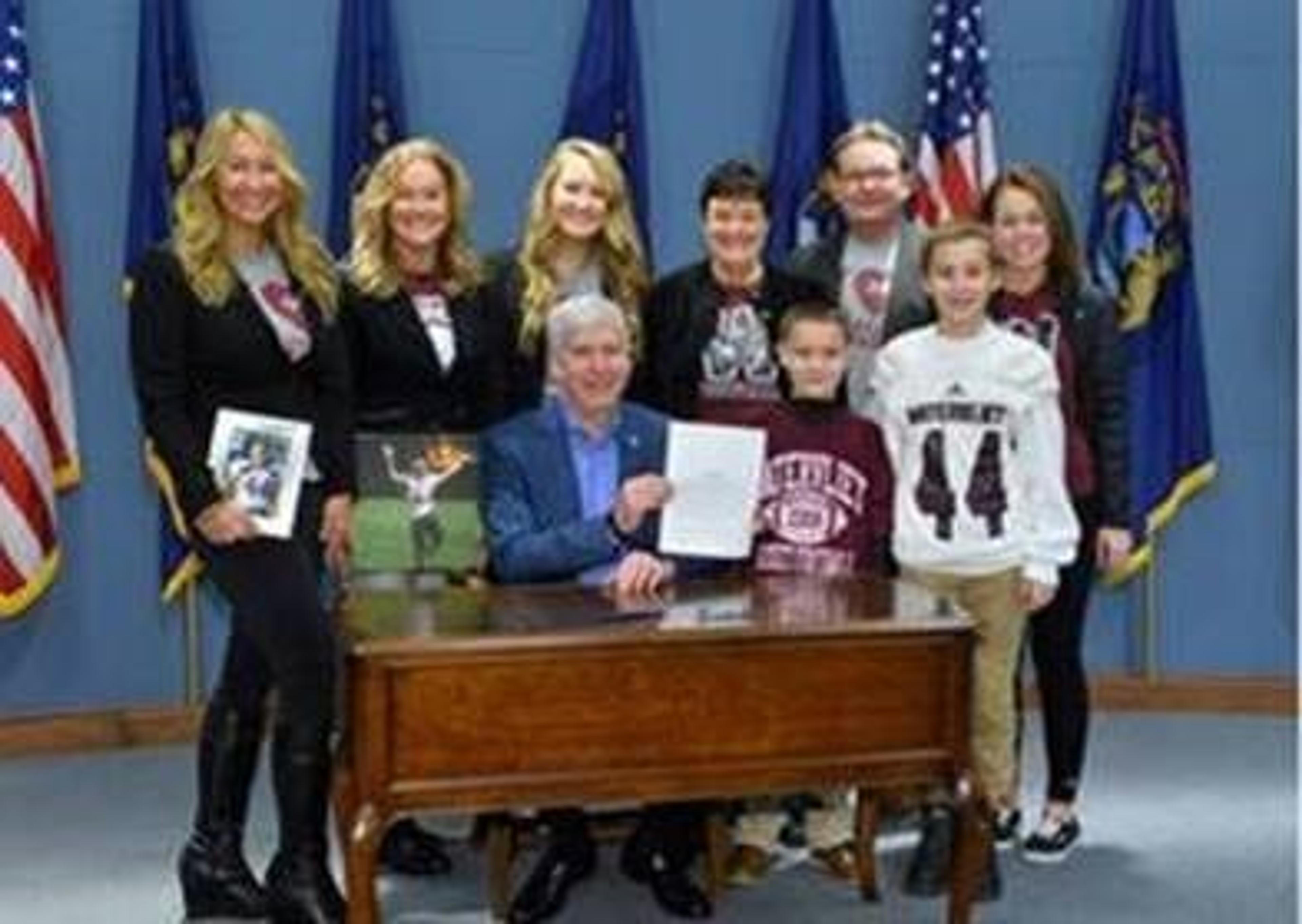 The Mizwicki and Huyser families with Michigan Governor Rick Snyder after expansions to the state's Good Samaritan Law were enacted.