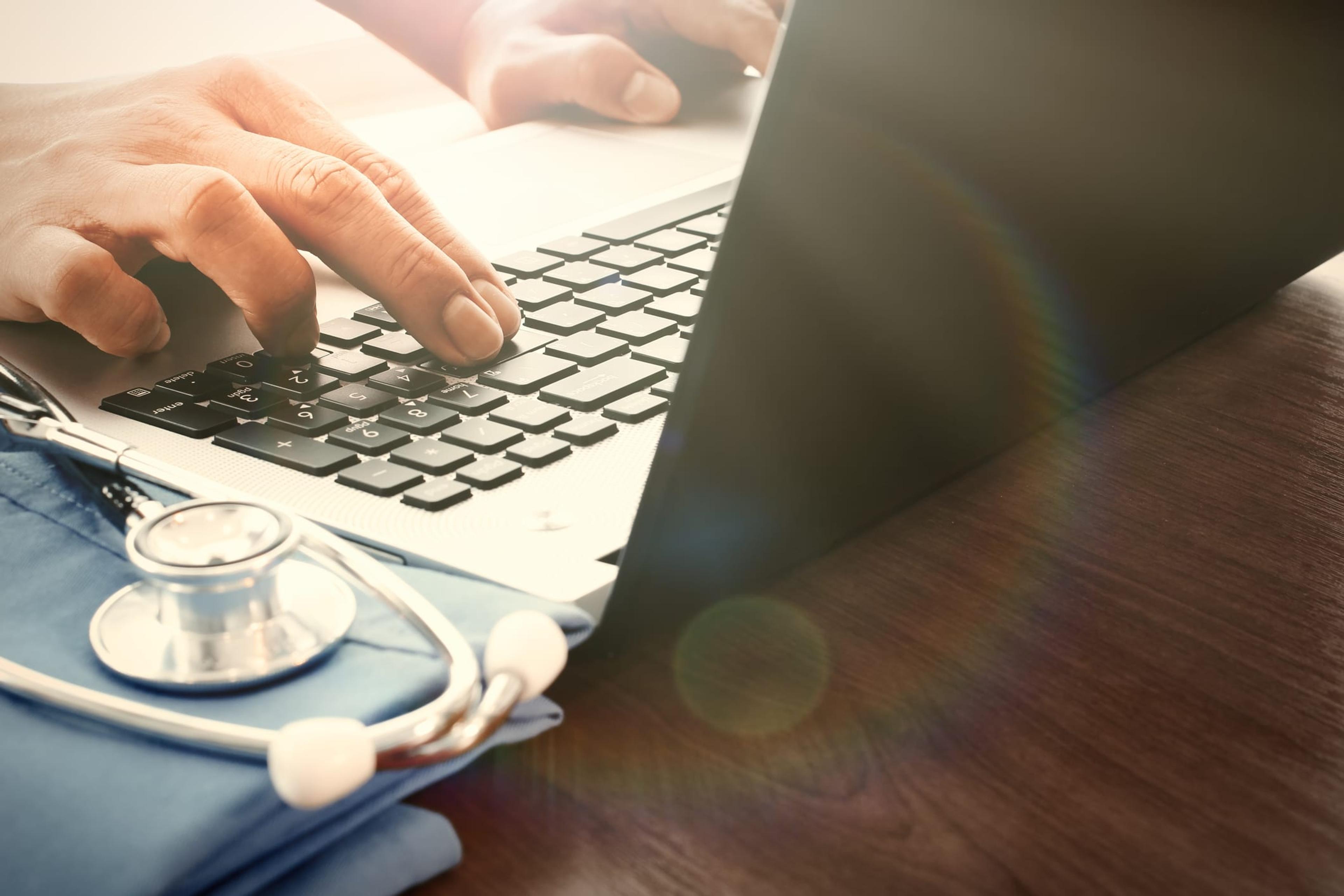 Doctor working on a laptop.