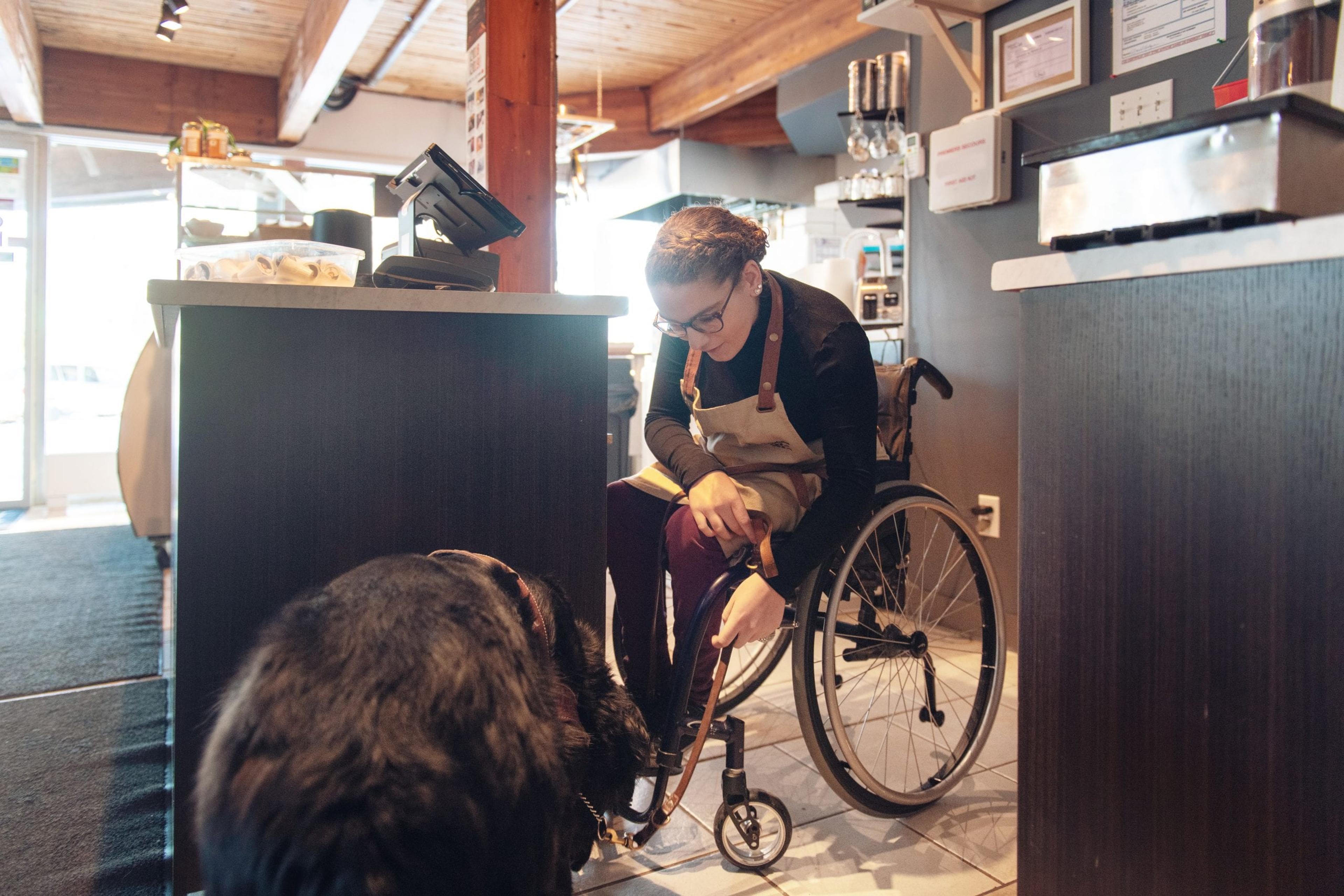 Worker in a wheelchair with her service dog