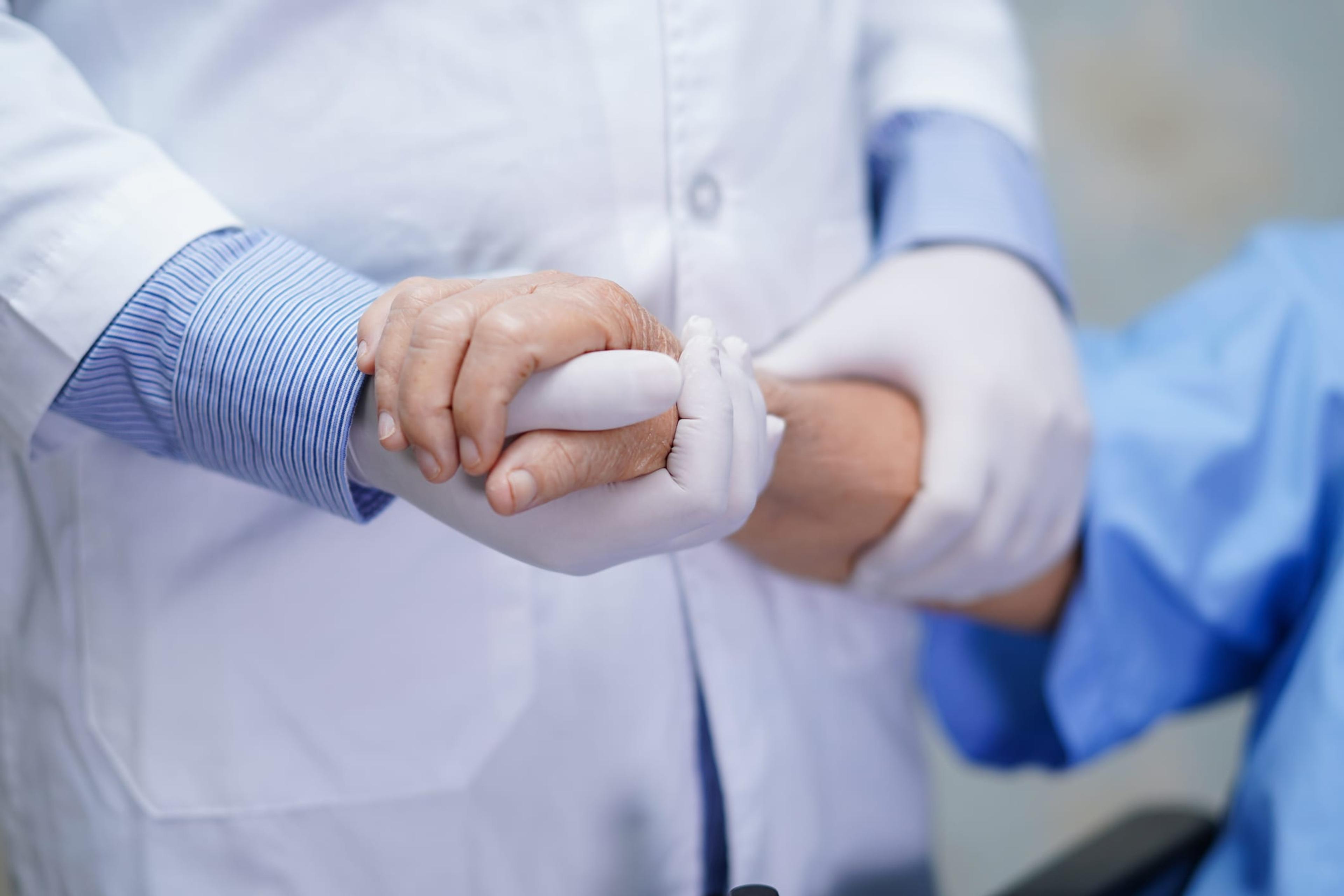 Doctor and patient holding hands