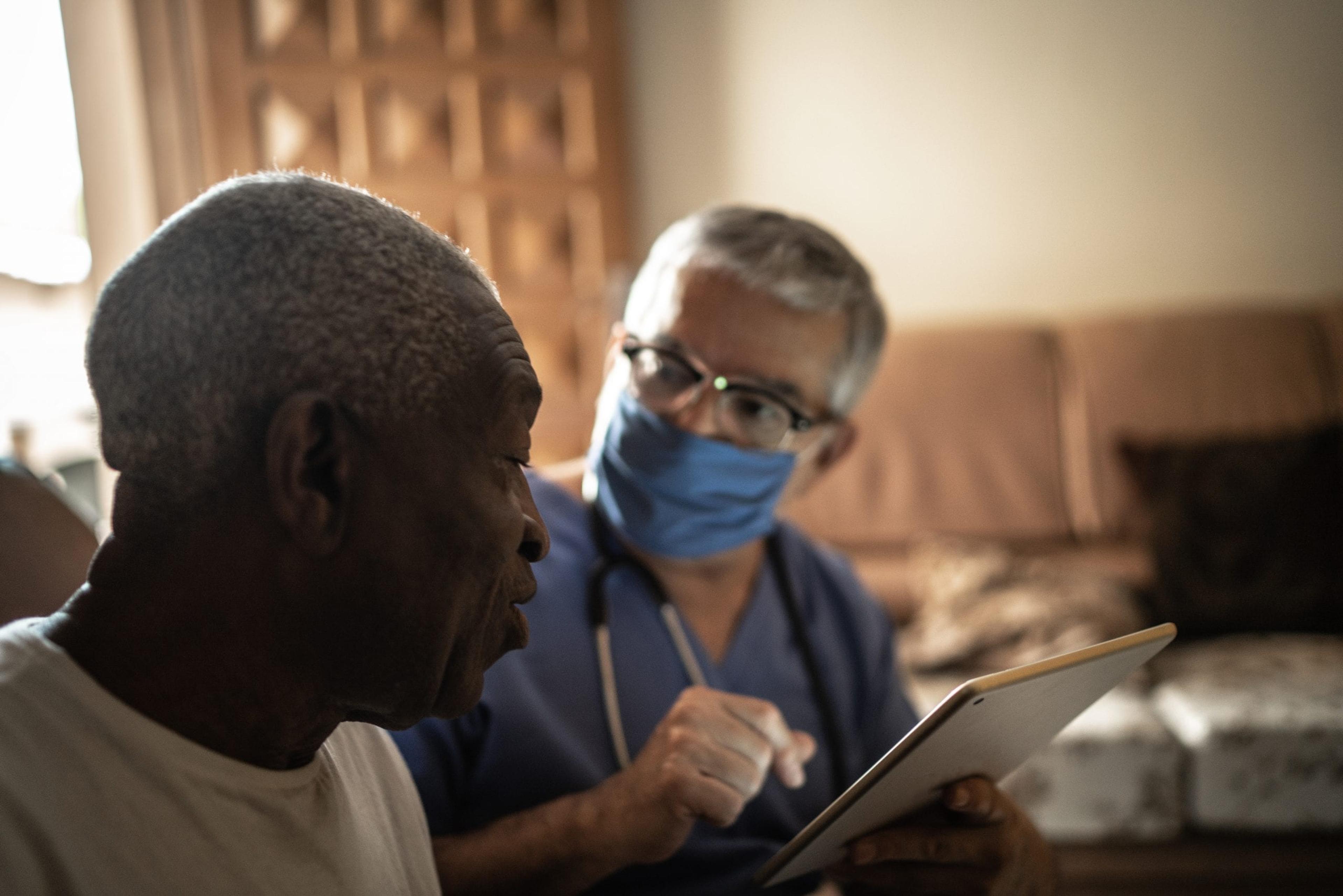 Doctor helping elderly man