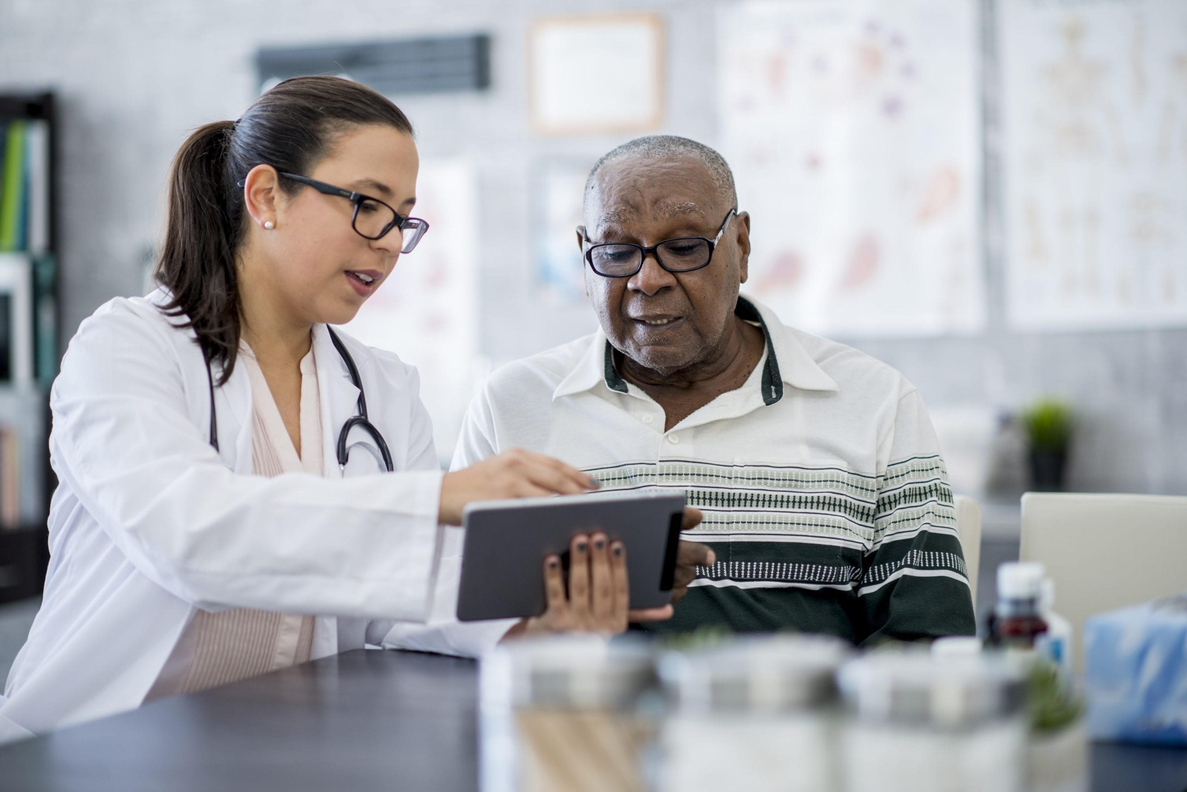 Image of a man being helped by his doctor.