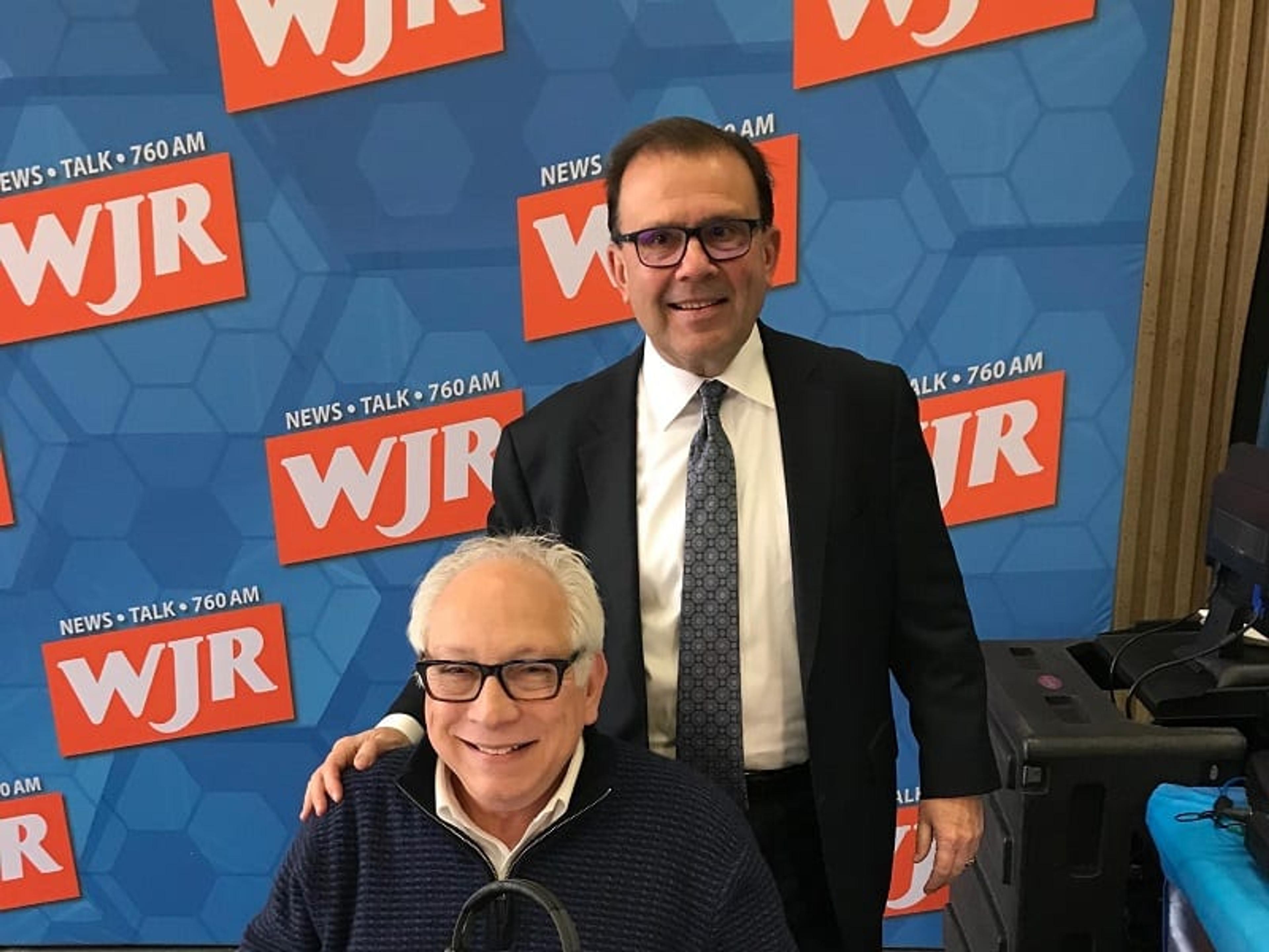 BCBSM CEO Daniel Loepp poses for a photo with WJR host Paul W. Smith