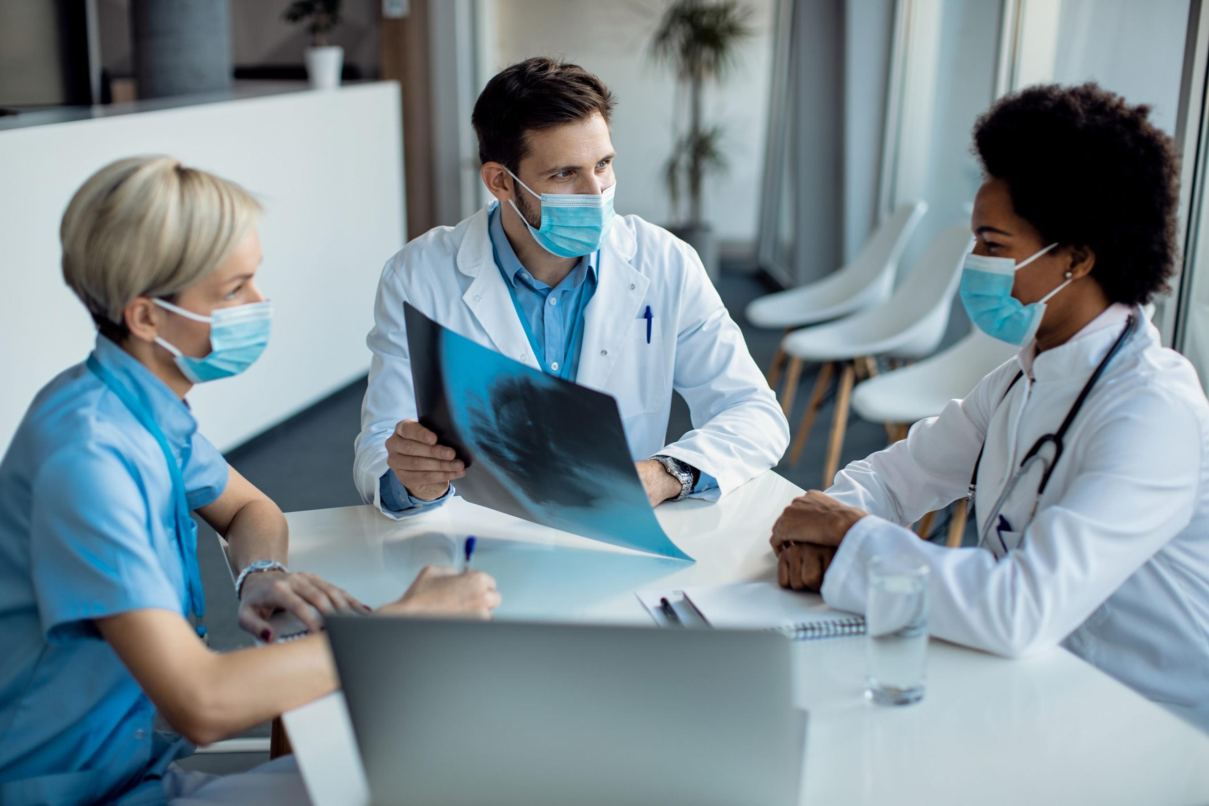 Team of doctors examining medical scan on a meeting at the hospital.