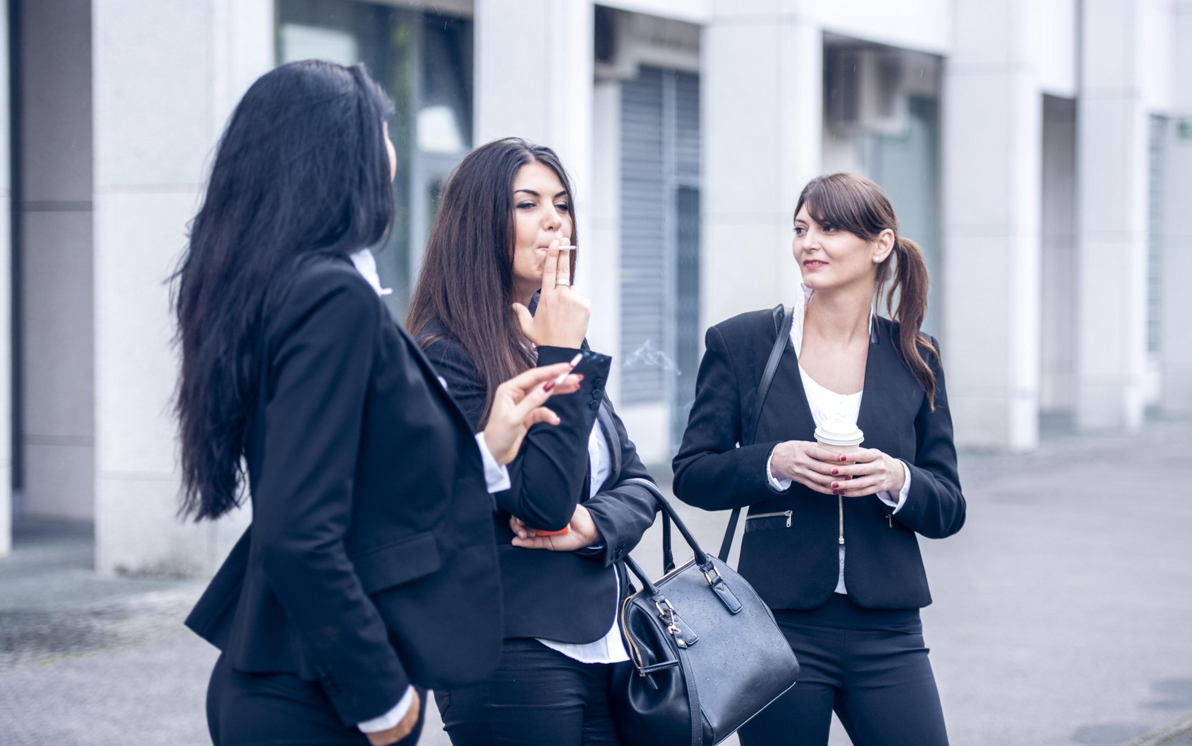 Women taking a smoke break outside their office