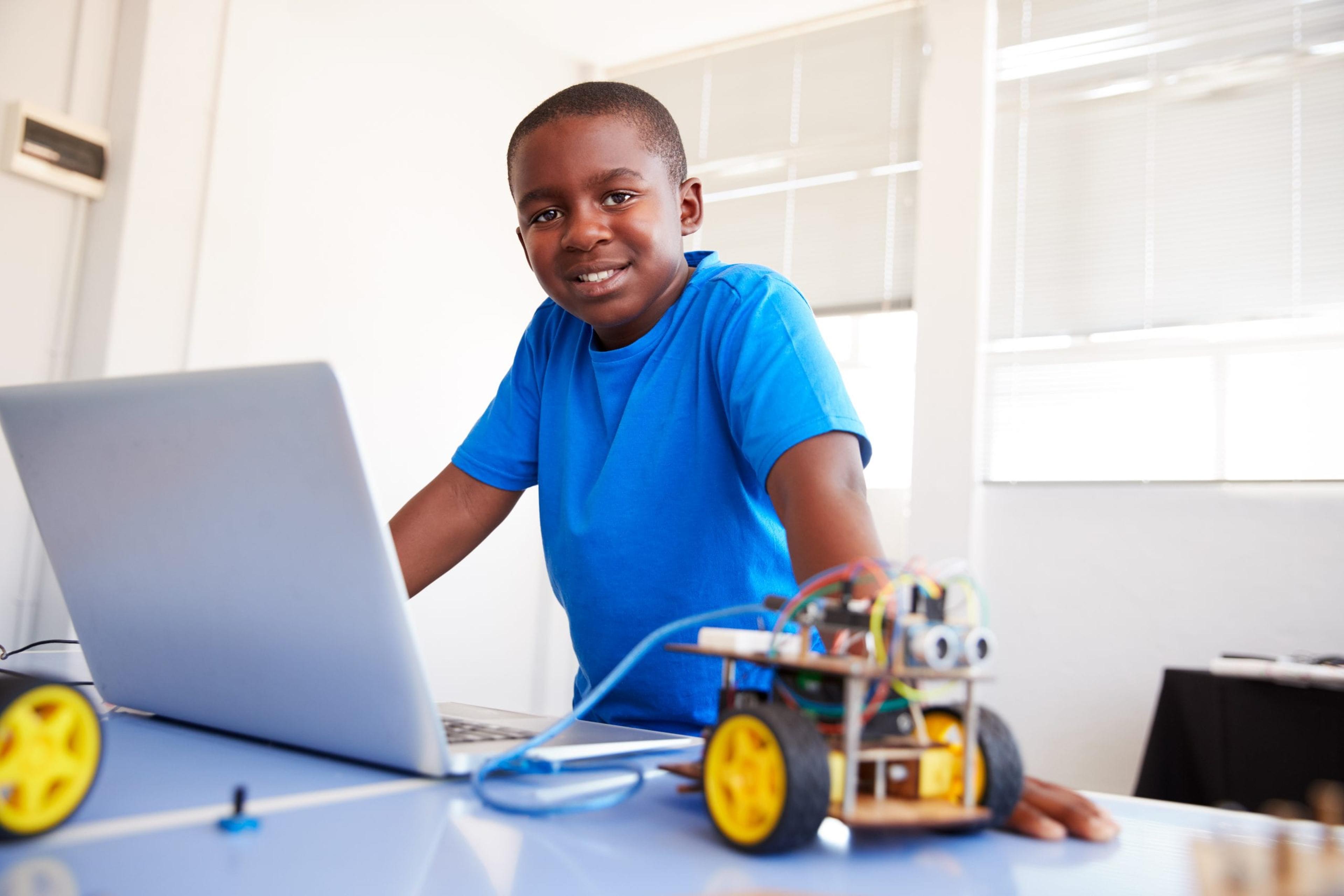 Young boy building a robot