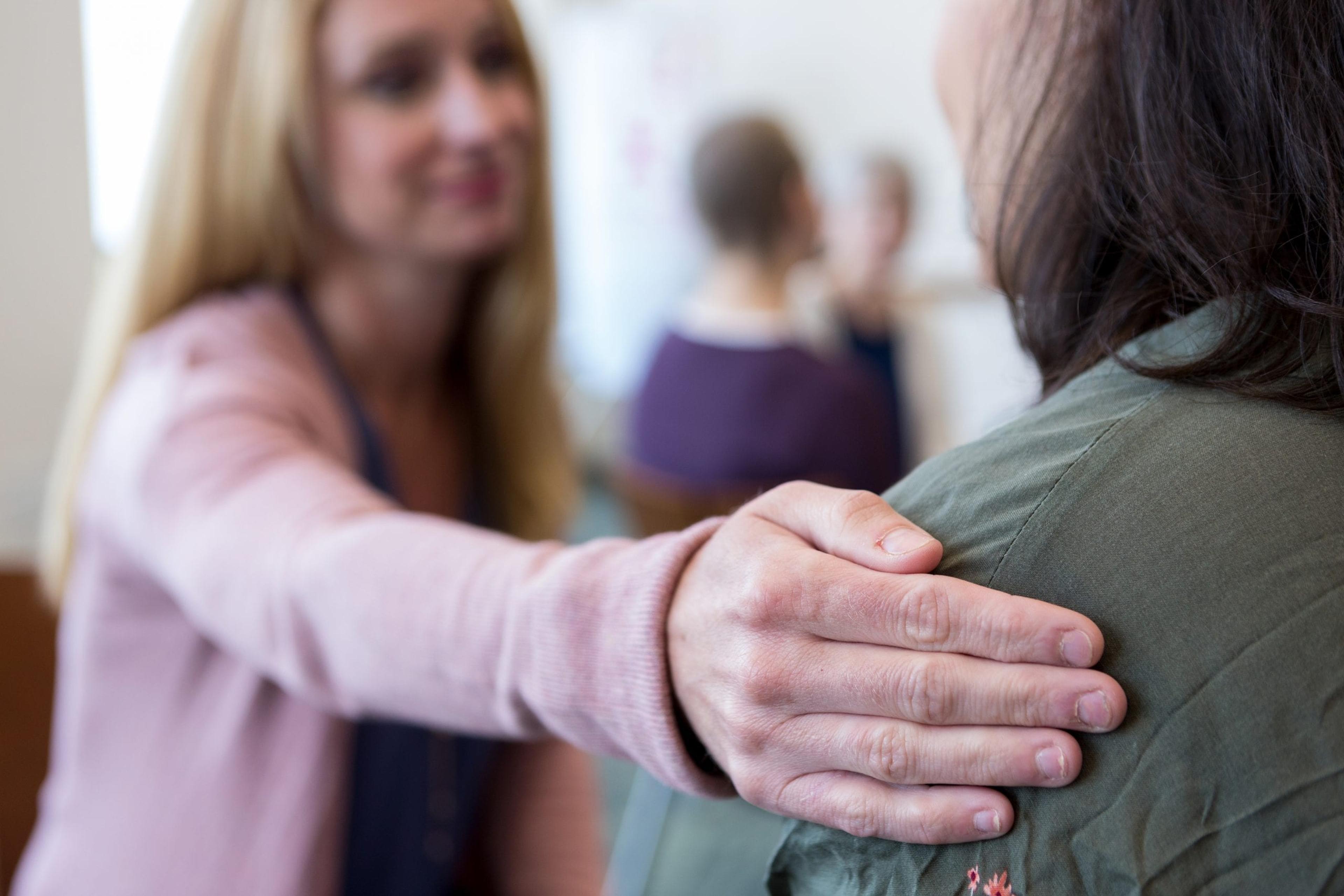 Woman comforting another woman