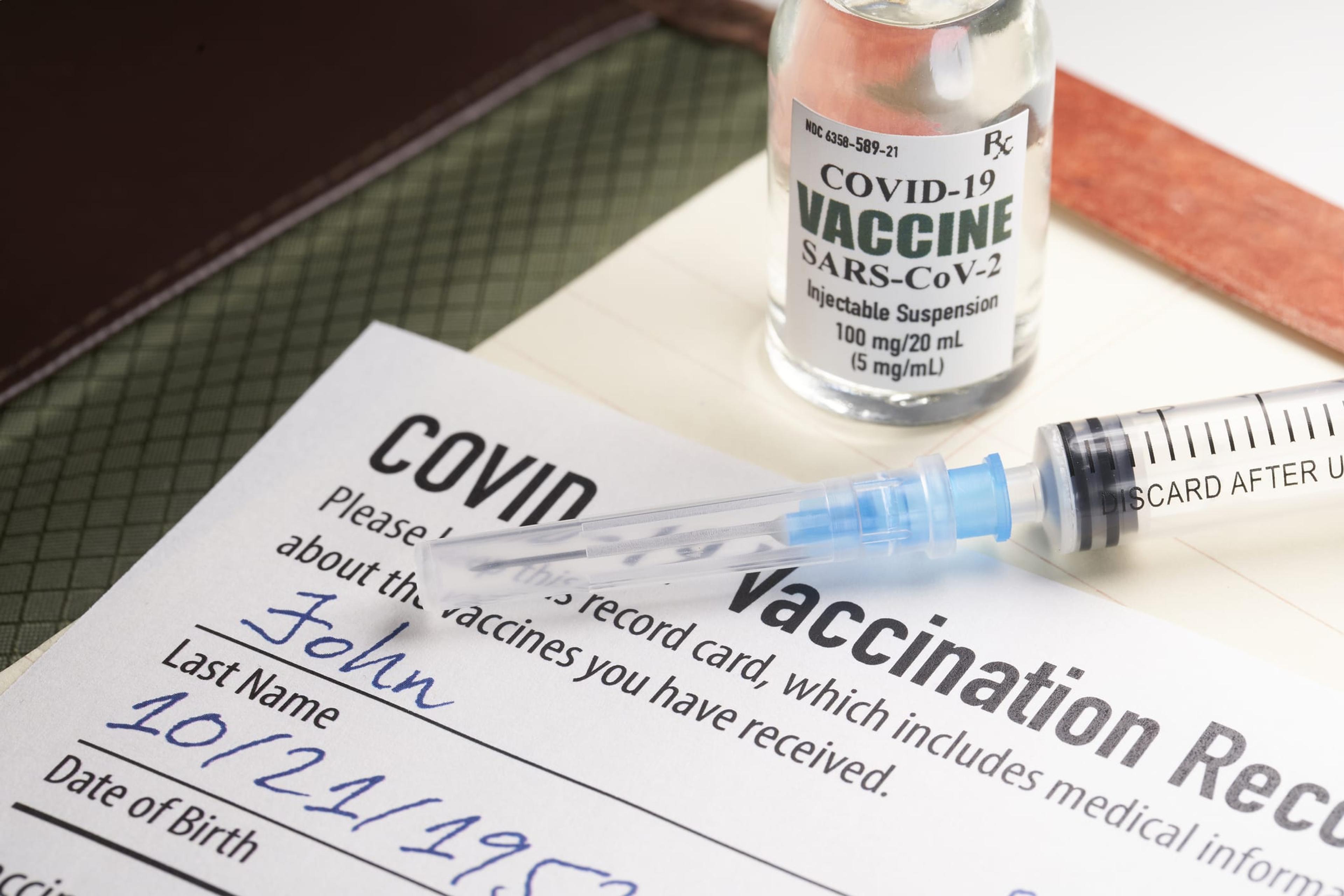 COVID-19 vaccine card with a syringe and vial