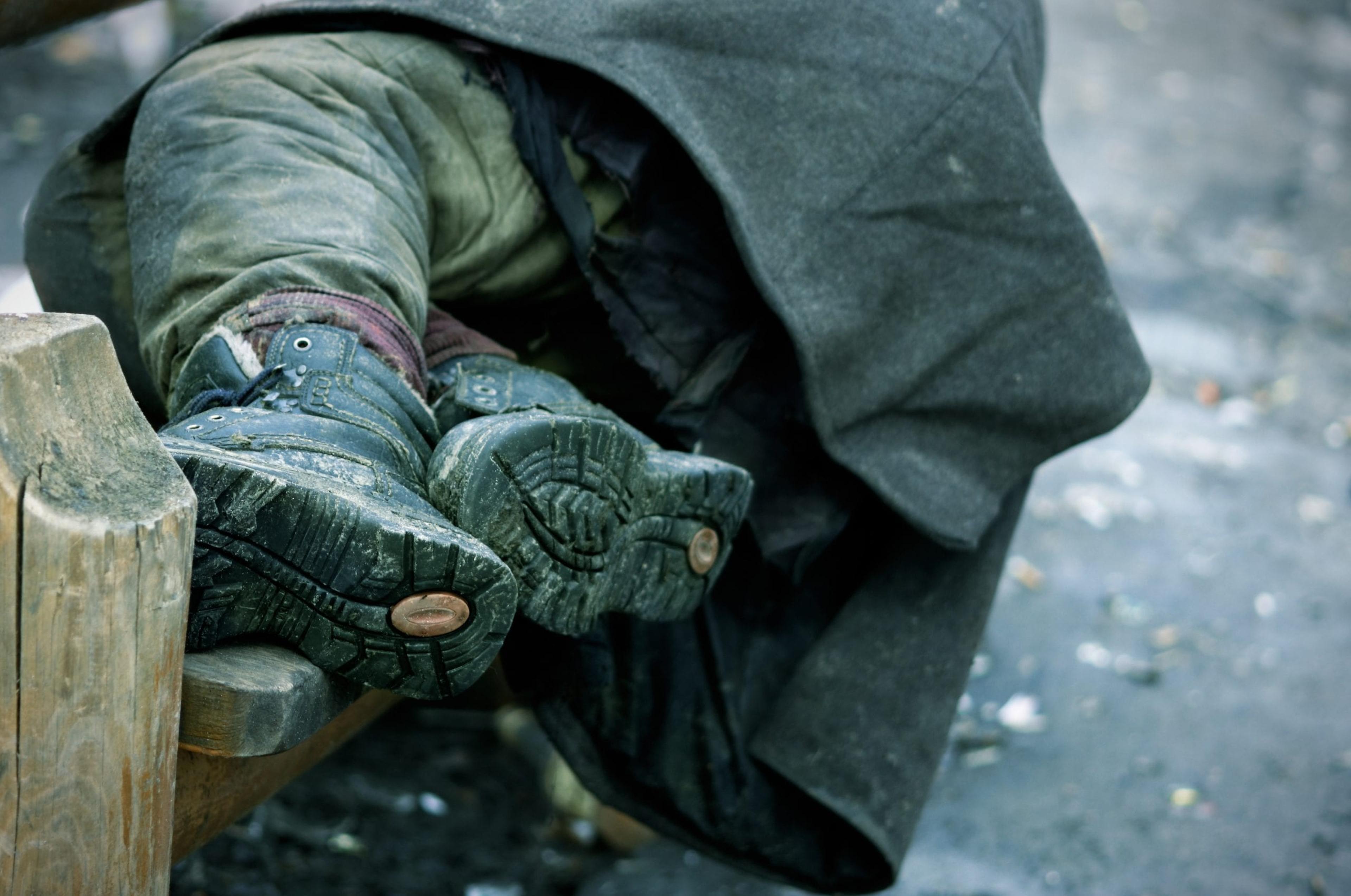 Homeless man sleeping on a bench
