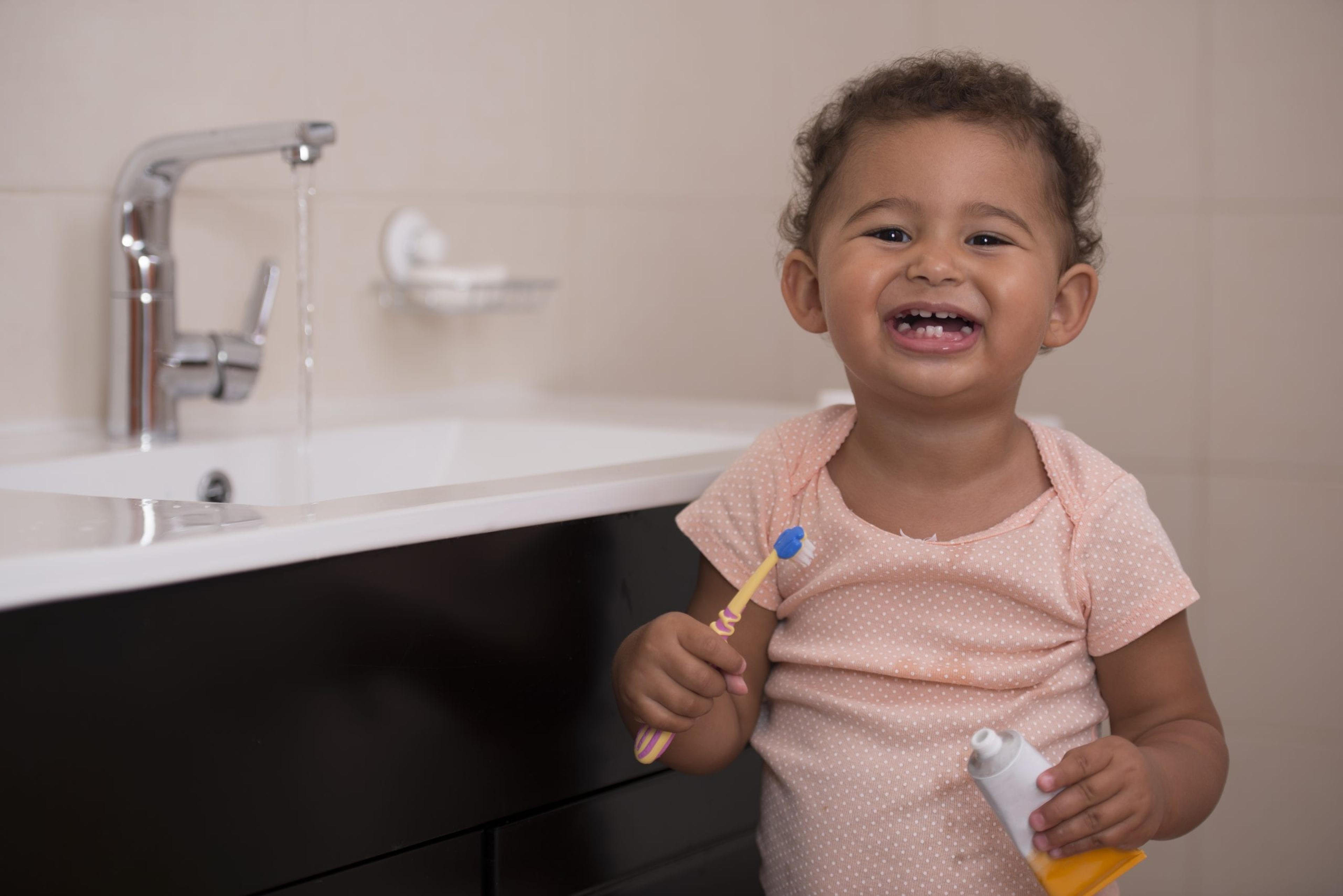 Image of a toddler brushing teeth.