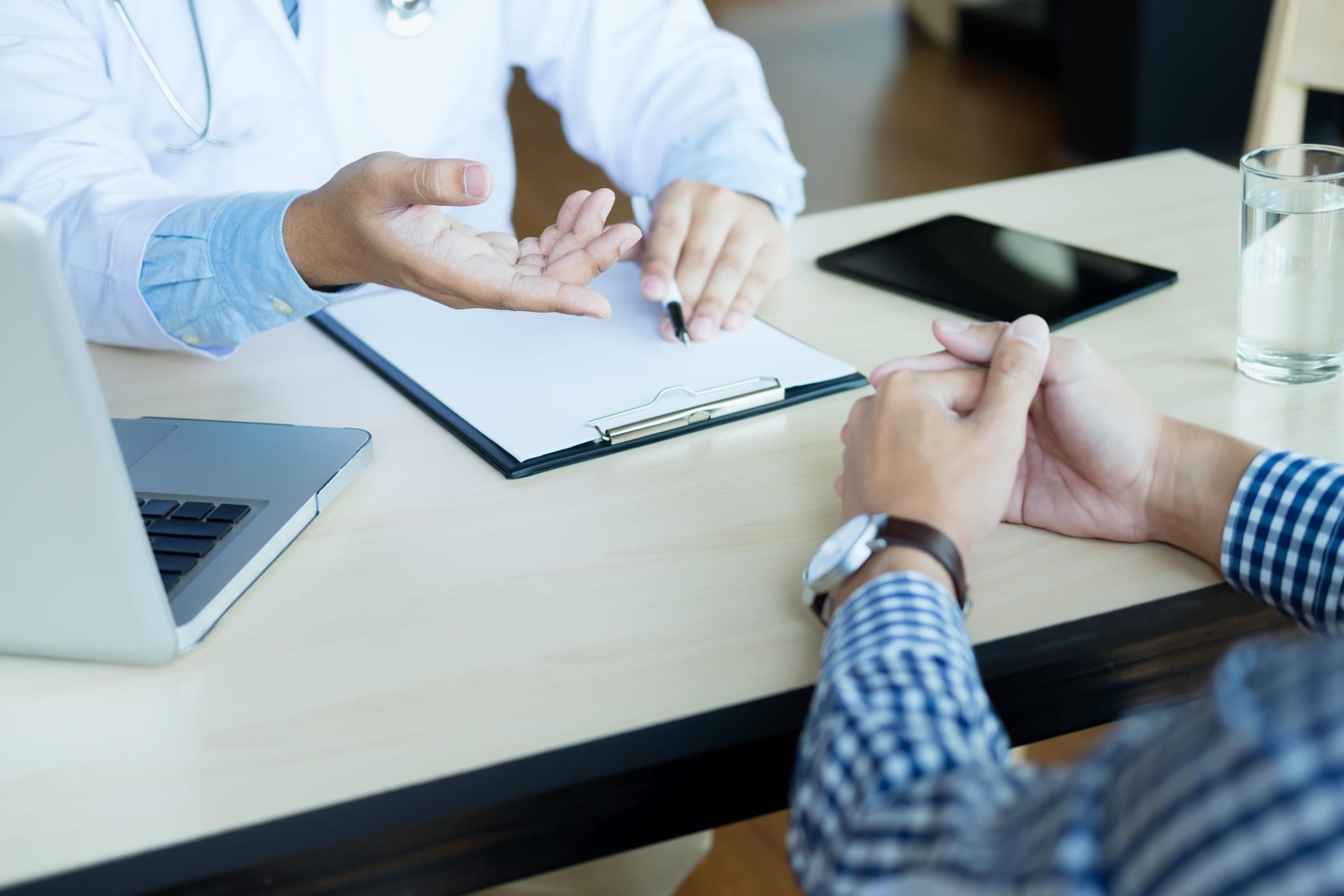 Doctor and patient are discussing something, just hands at the table