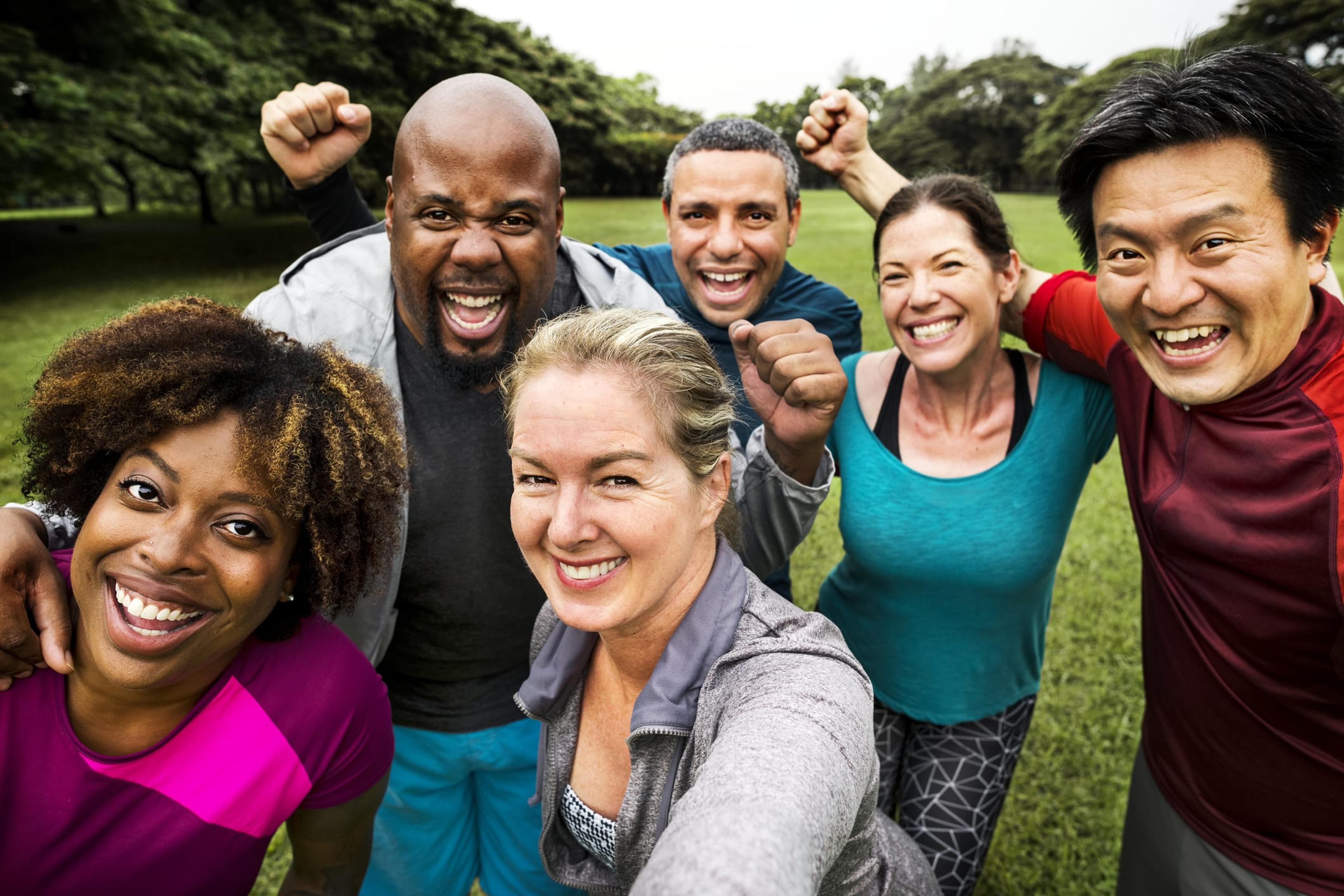 Group of people taking a selfie after a workout in the park.