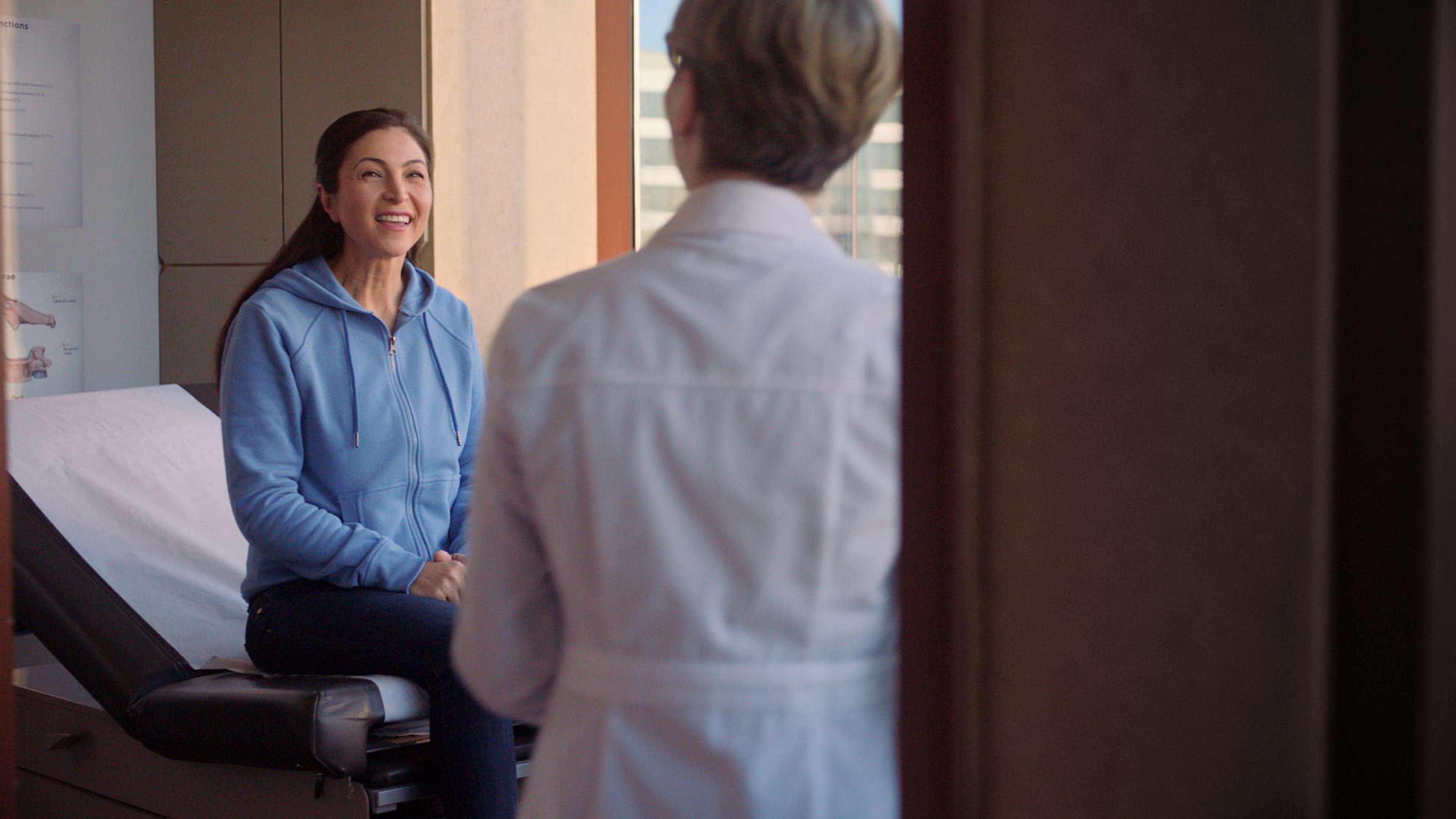 Woman smiling at a doctor during a check up
