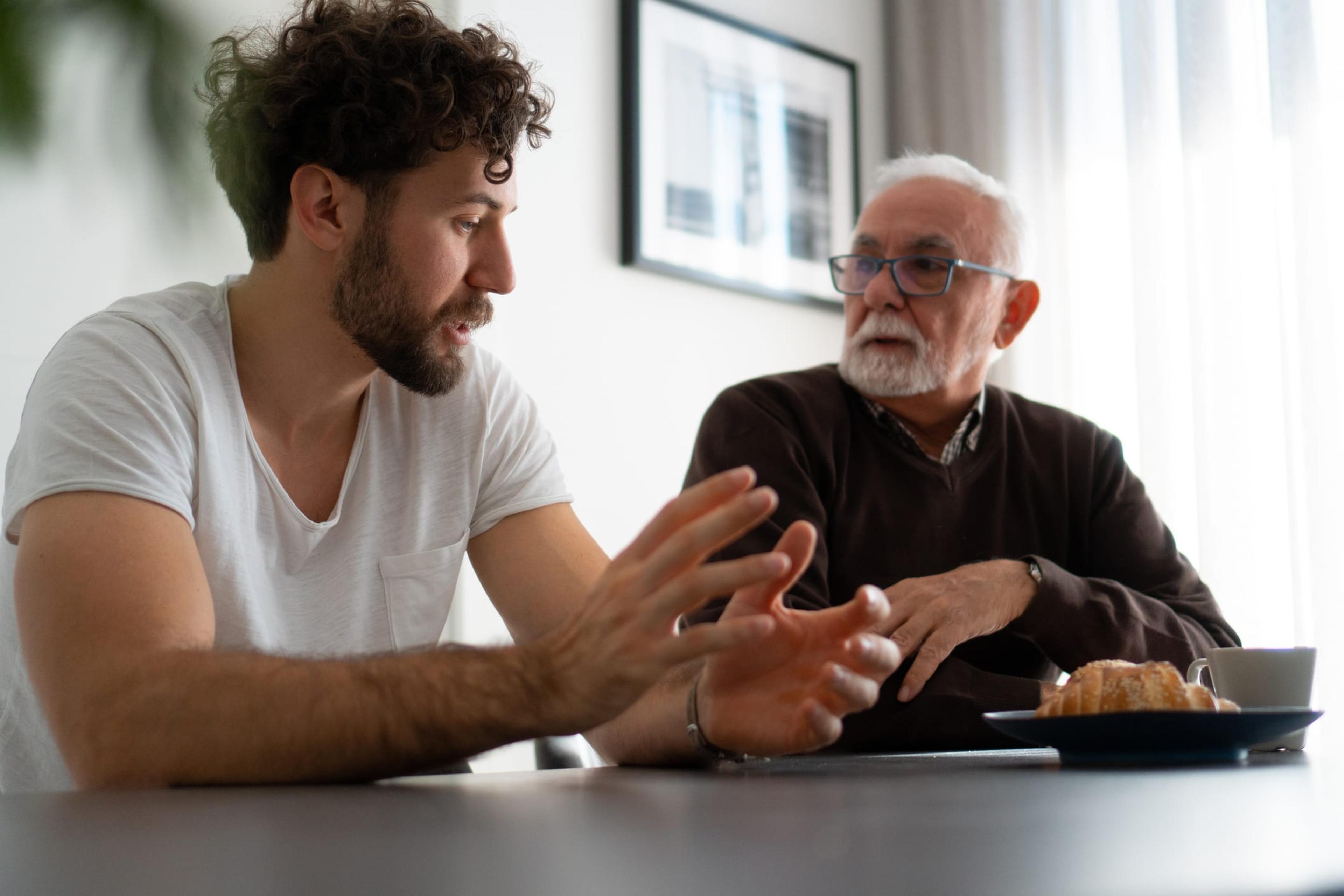 Young man in a deep discussion with an older man about vaccine hesitancy