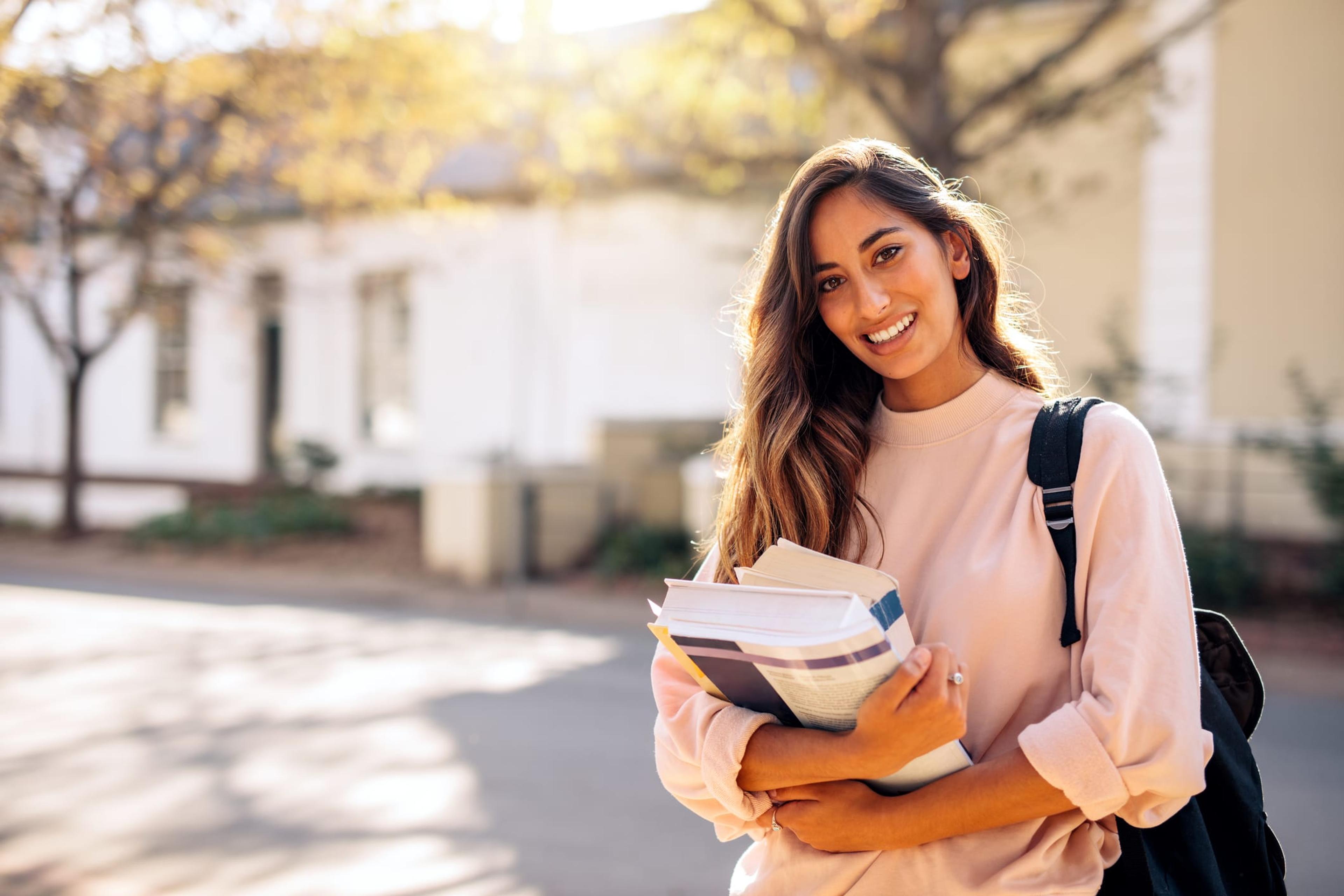 image of female college student holding books