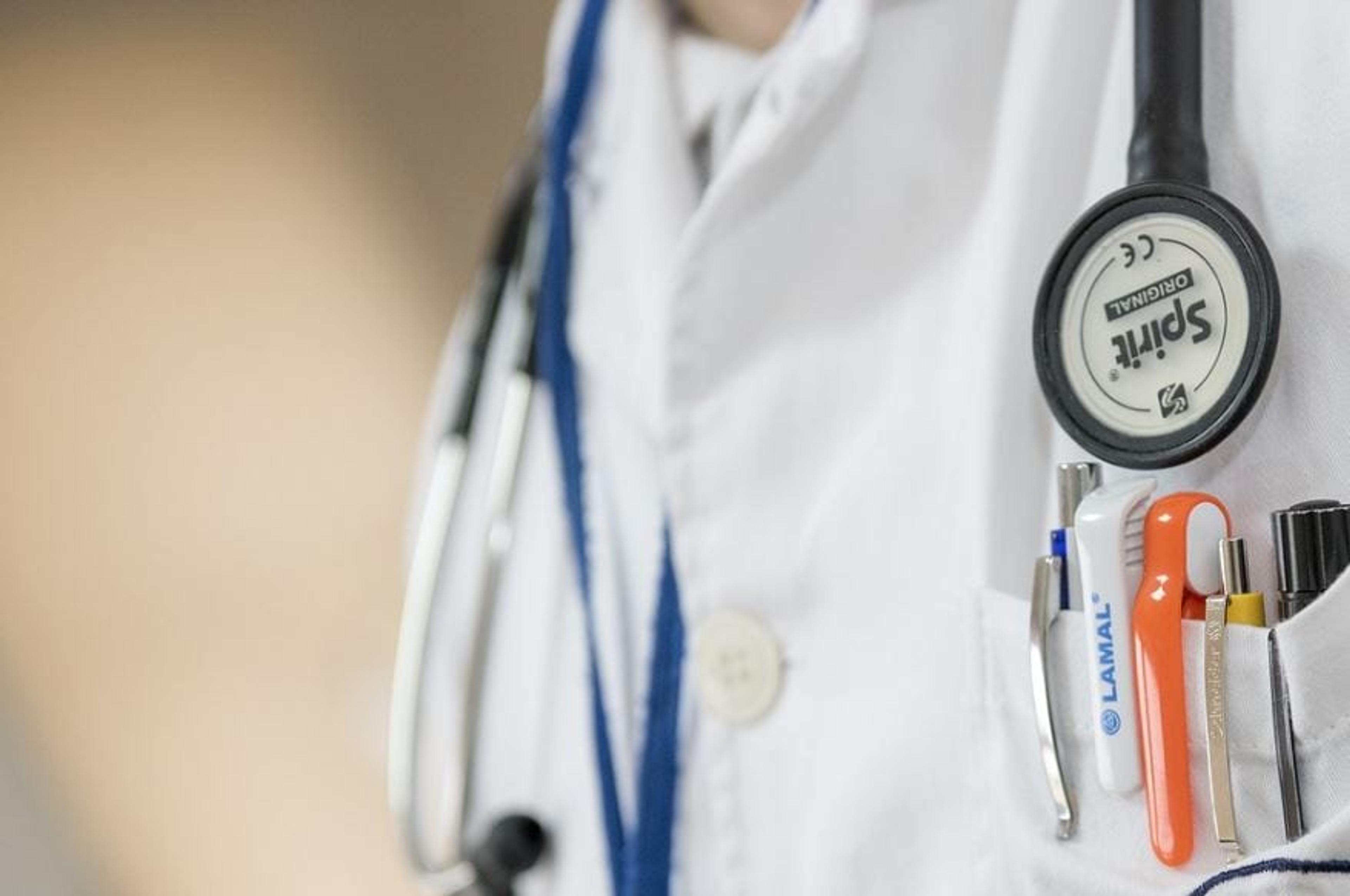 Doctor's chest with a white coat, stethoscope and pens in the pocket