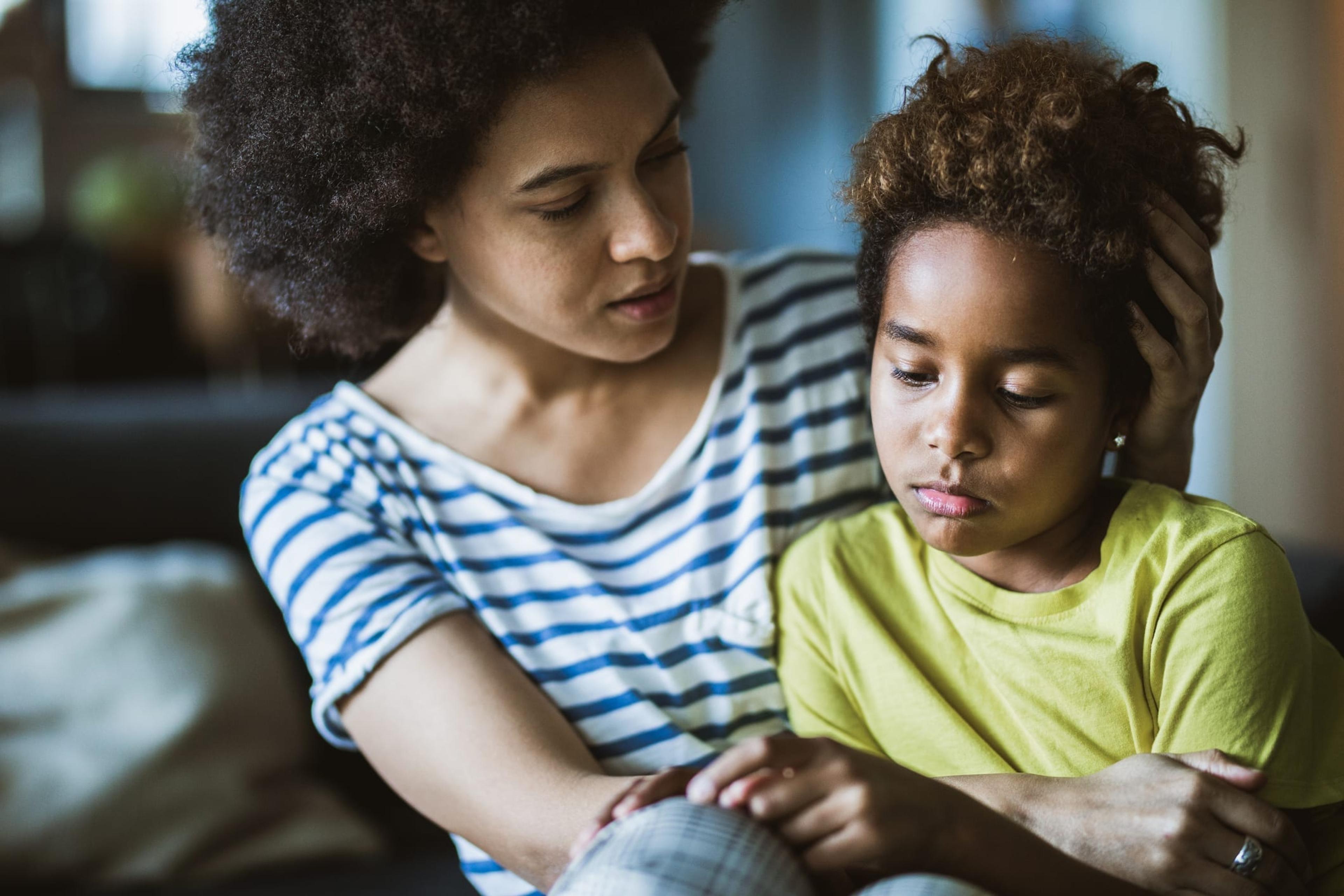 Mother comforts sick child