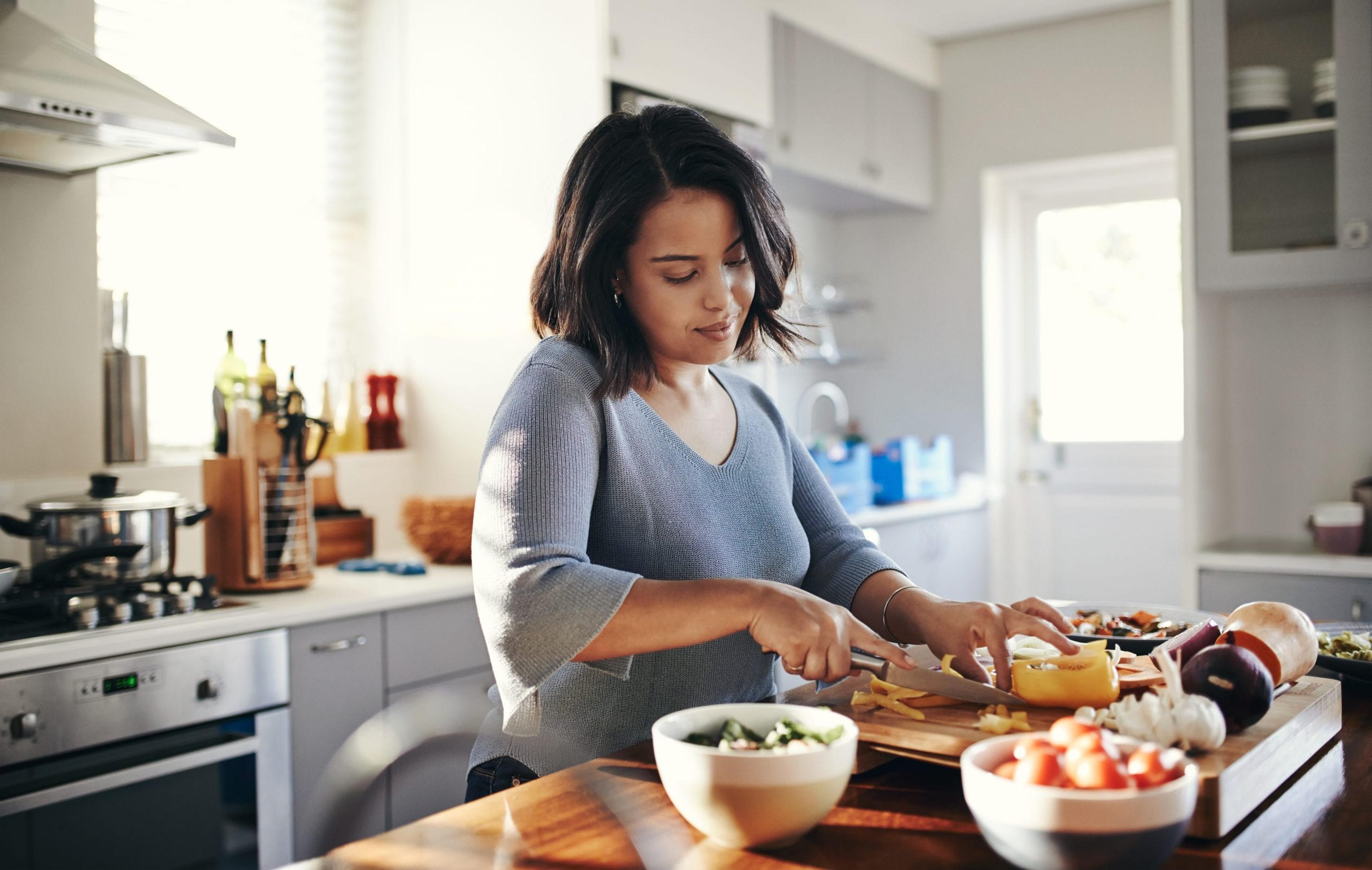 Young woman cooking dinner.