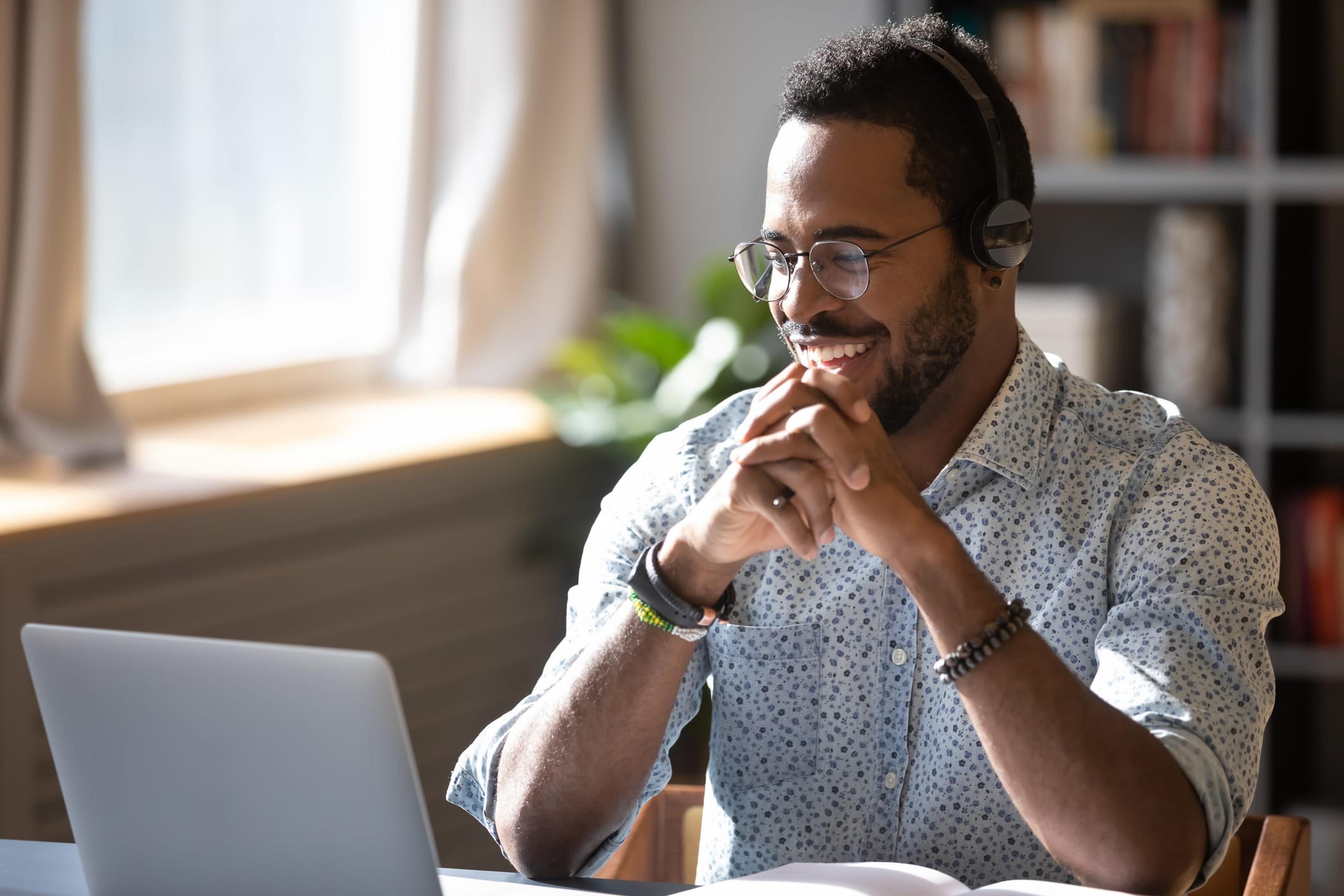 Man smiling while using computer