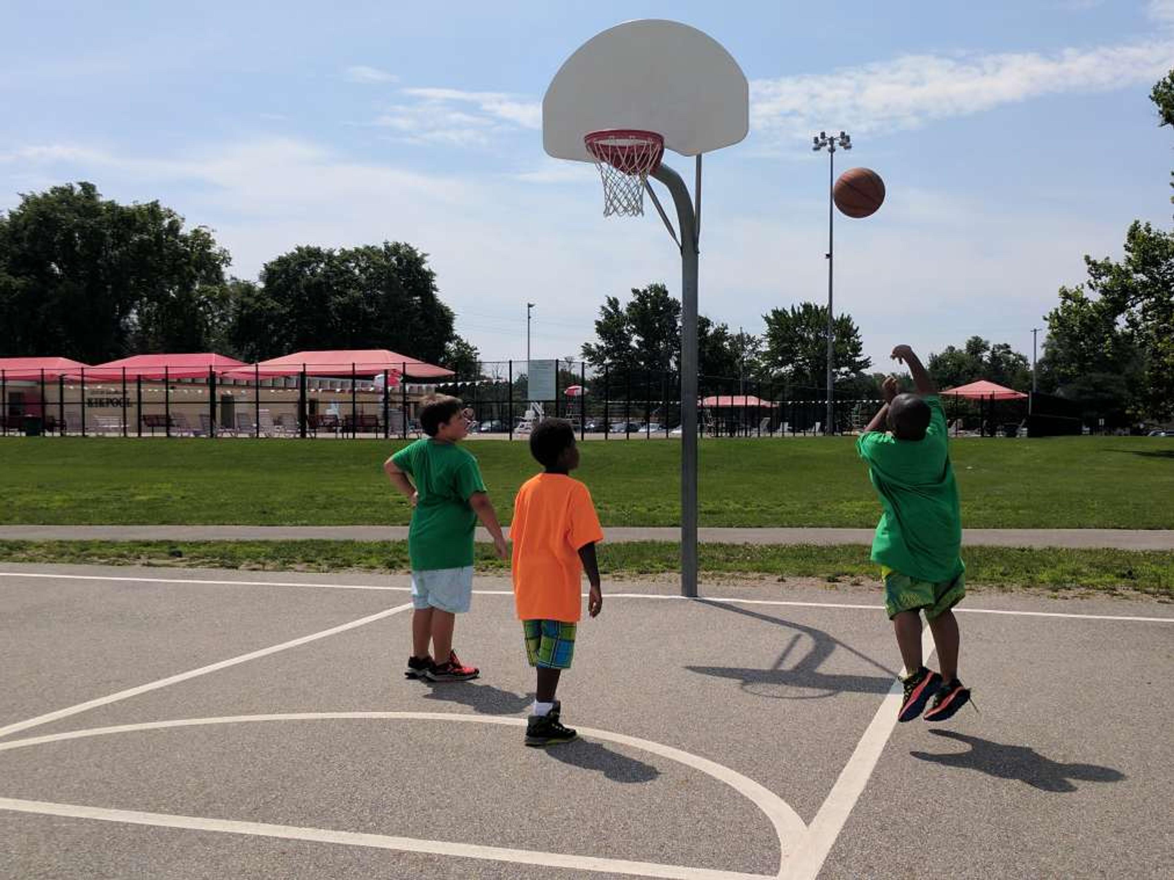 Boys playing basketball outside