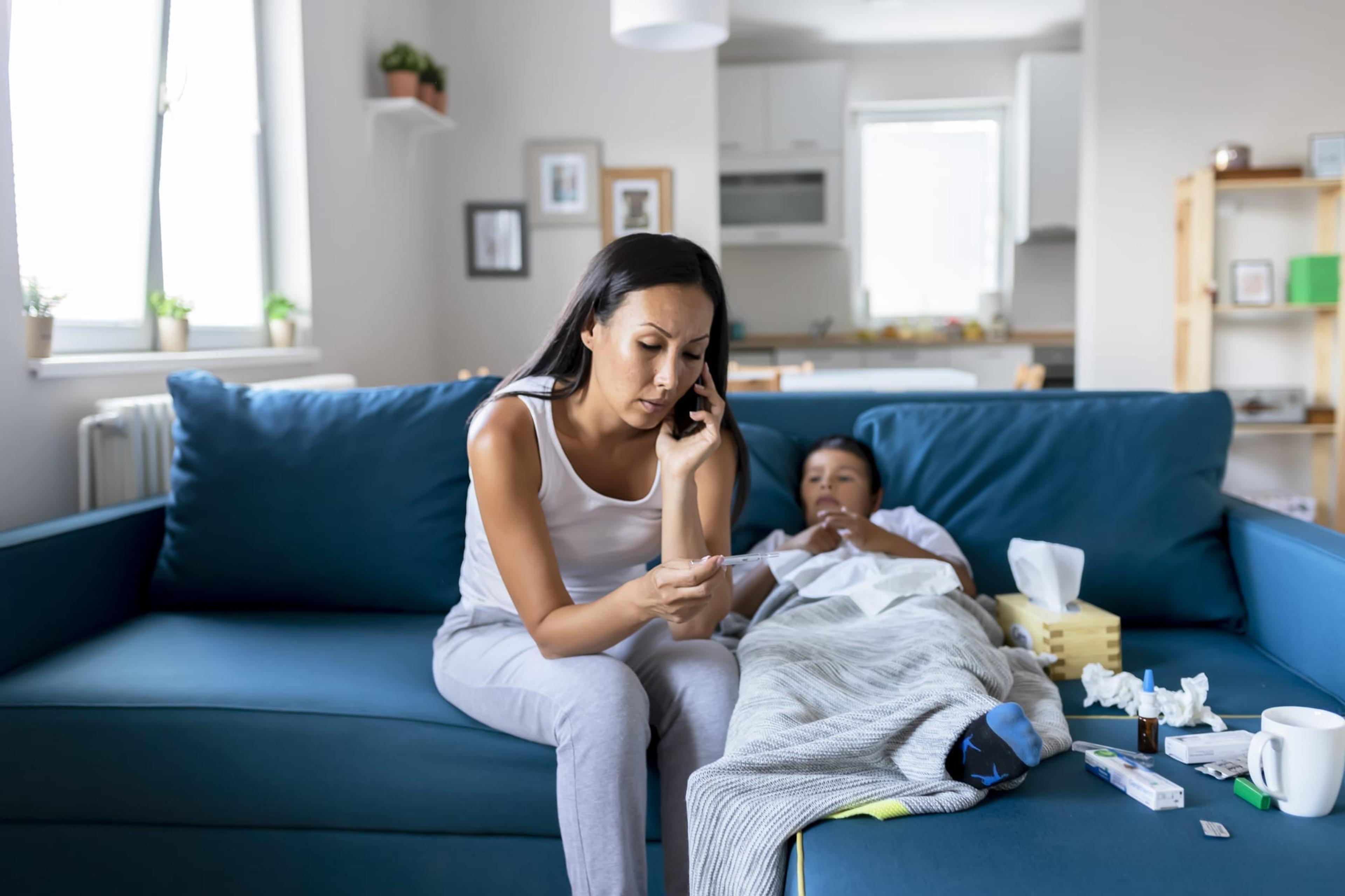 A woman using her phone to contact the 24-hour nurses line and schedule a virtual visit