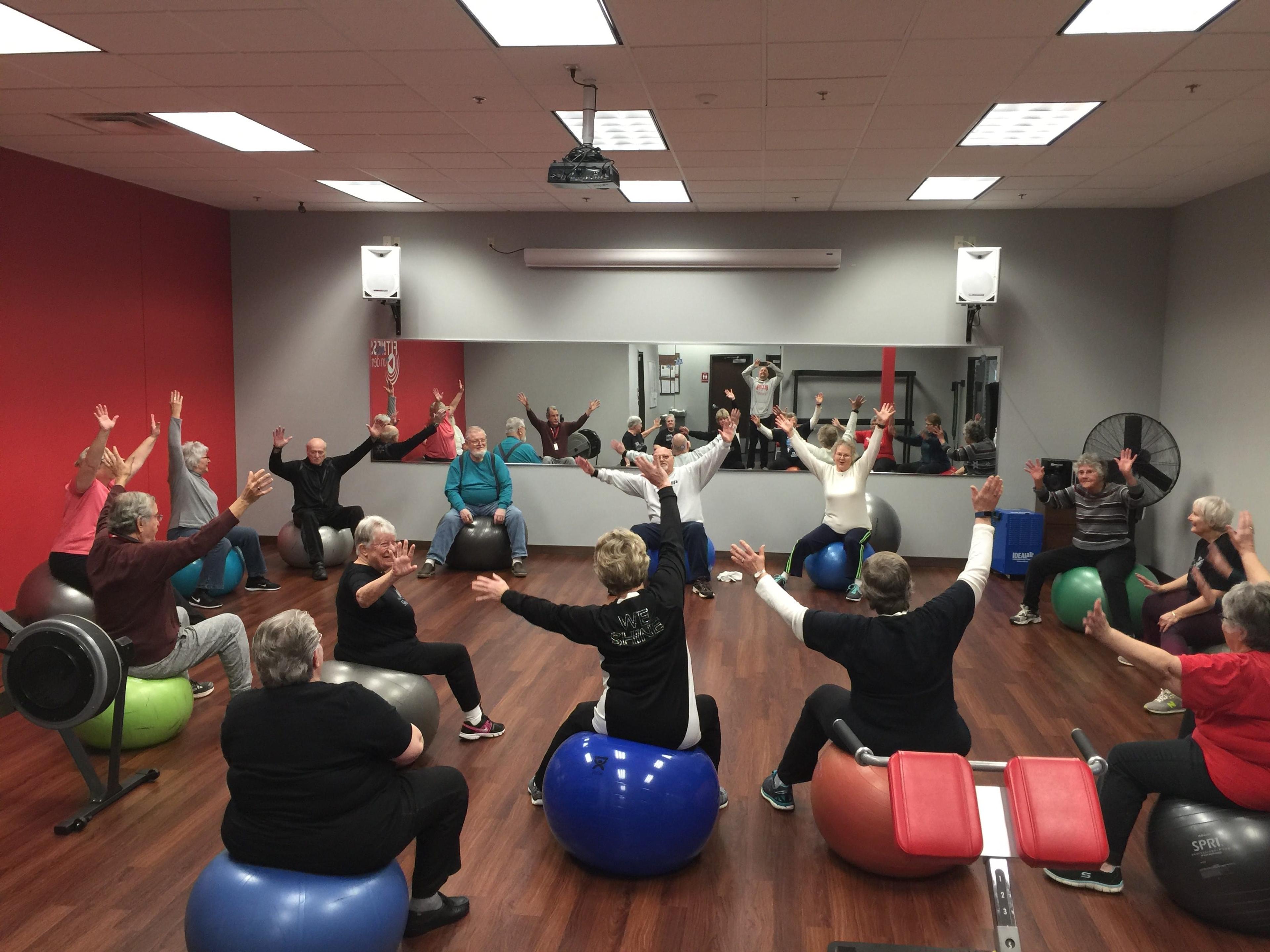 Image of Sally Miller working out with other Silver Sneakers members at Snap Fitness.
